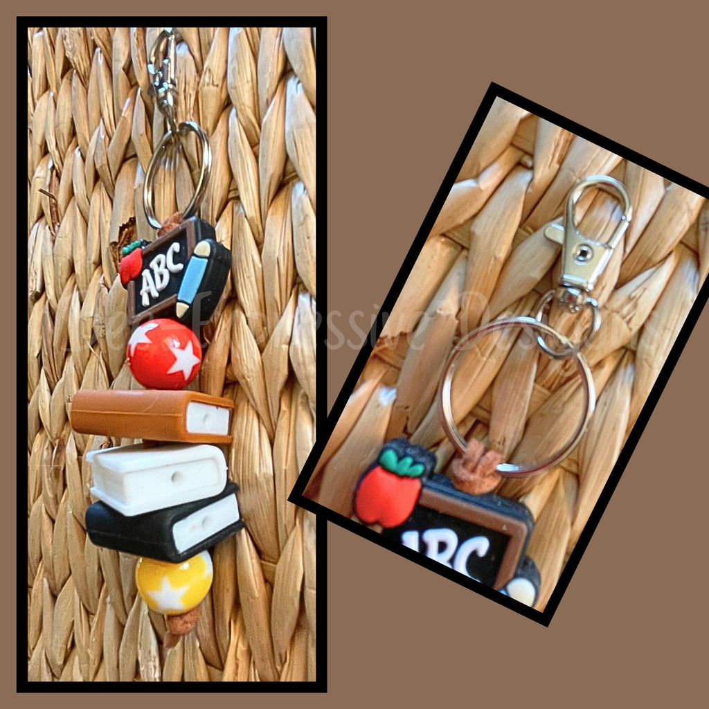 Handmade, cute, TEACHER keychain with 3 silicone books, red & yellow acrylic beads with stars, and a focal ABC silicone chalkboard bead!