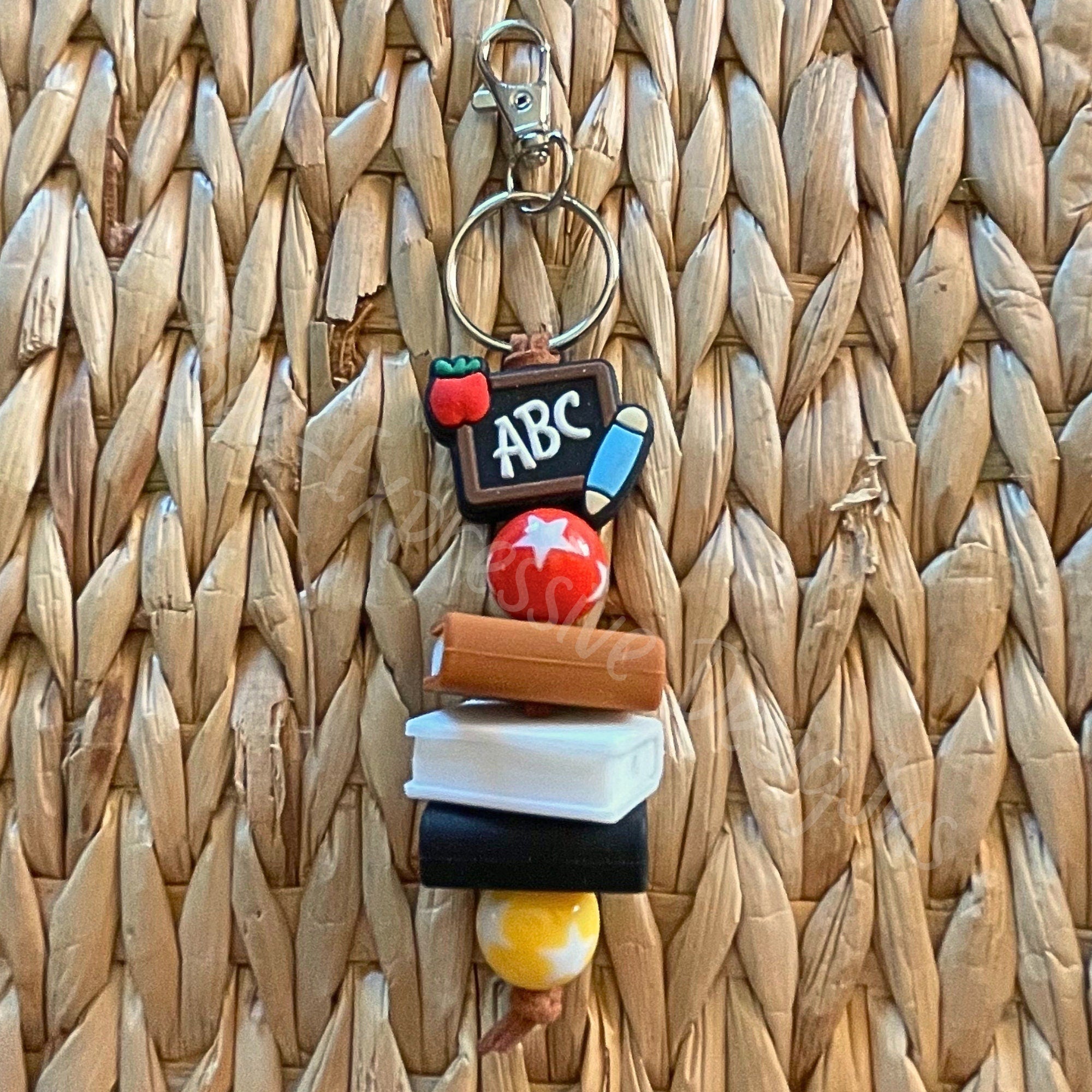 Handmade, cute, TEACHER keychain with 3 silicone books, red & yellow acrylic beads with stars, and a focal ABC silicone chalkboard bead!