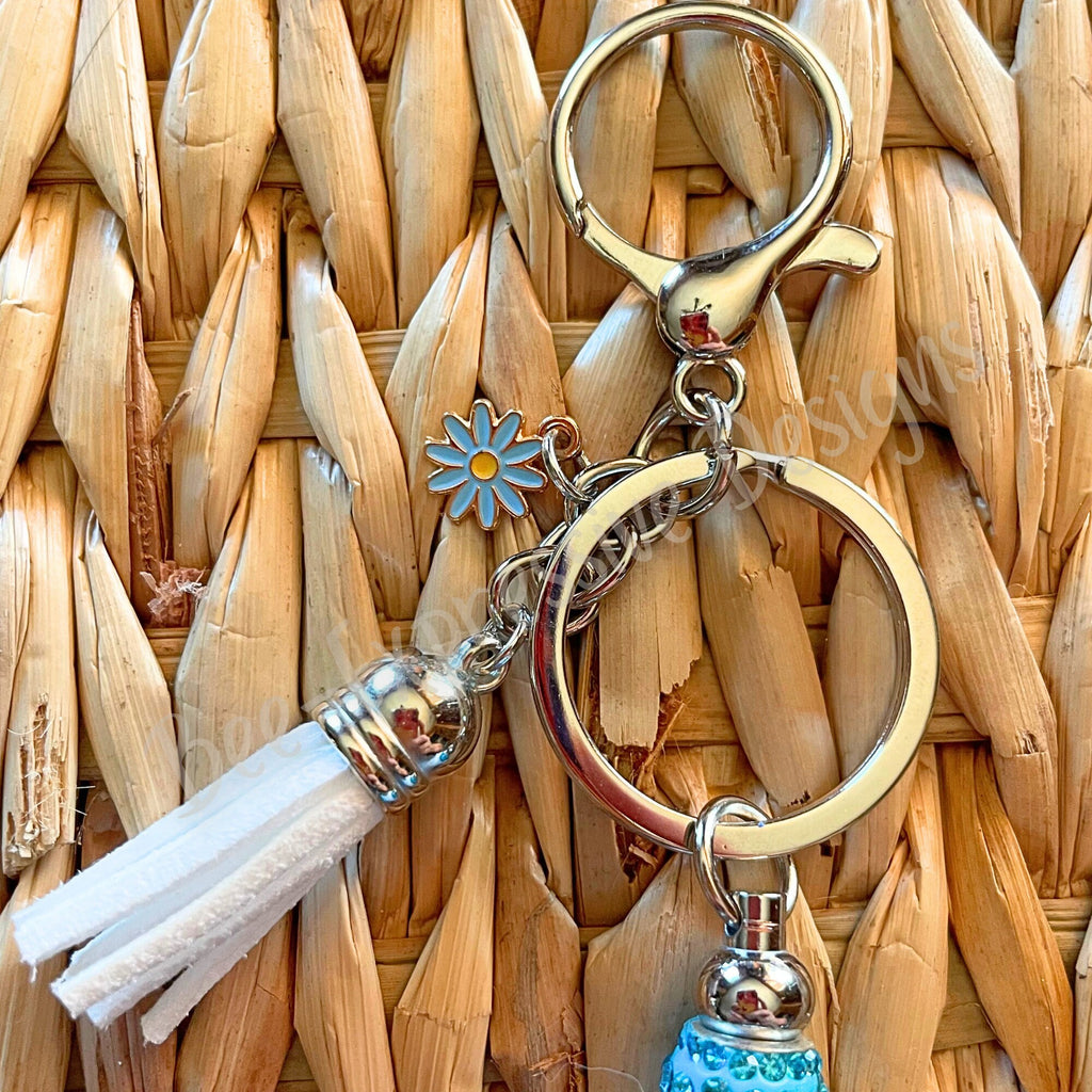 Adorable, handmade, TEACHER keychain with a book, daisy charm, tassel, & a silicone rubber focal cup bead that reads Coffee, Teach, Repeat!