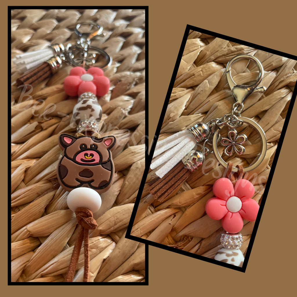 Adorable, handmade cow/bull keychain! Lobster claw clasp, keyring, cord, rhinestones, flower, brown cow print bead, tassels, flower charm