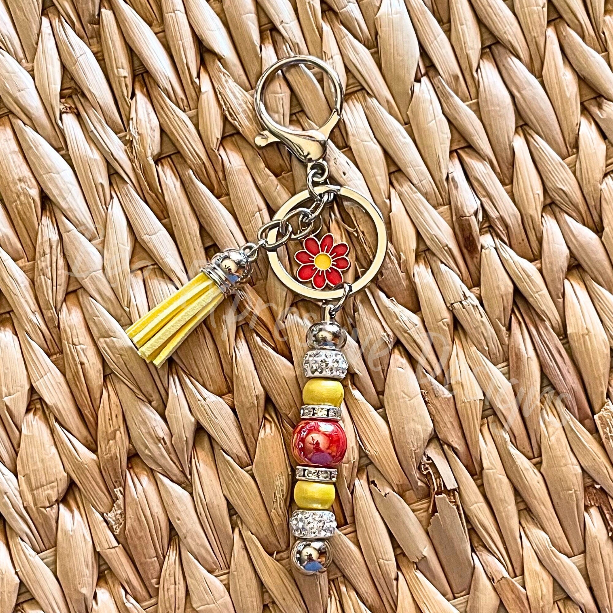 Beautiful, handmade keychain with iridescent beads and a red daisy charm!