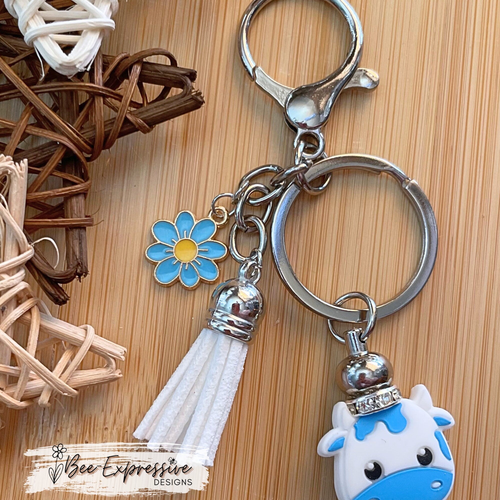 Beautiful handmade baby blue cow keychain with a 20mm rhinestone bead and a daisy charm!