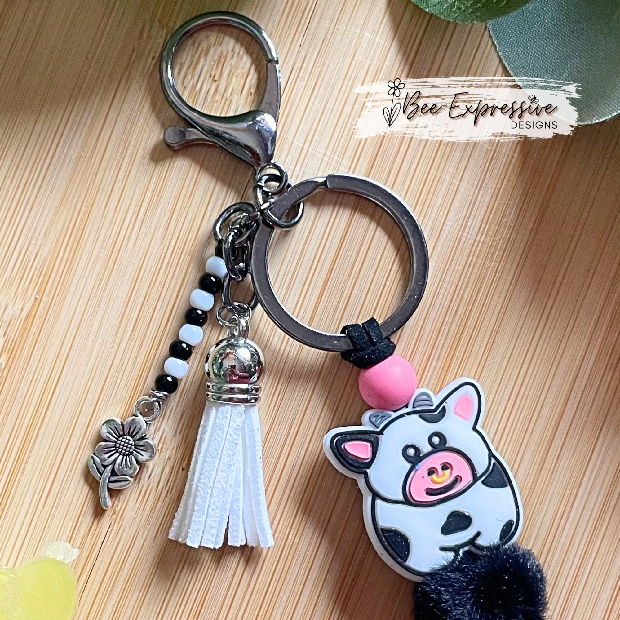 Adorable, handmade, bull cow keychain! Furry beads, animal print wood beads, acrylic beaded tassel with metal flower charm!