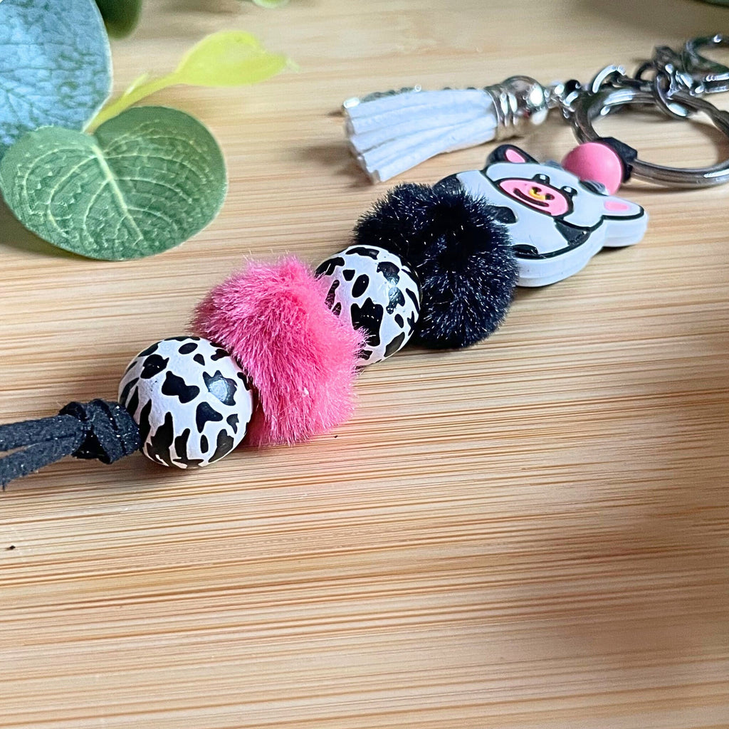 Adorable, handmade, bull cow keychain! Furry beads, animal print wood beads, acrylic beaded tassel with metal flower charm!