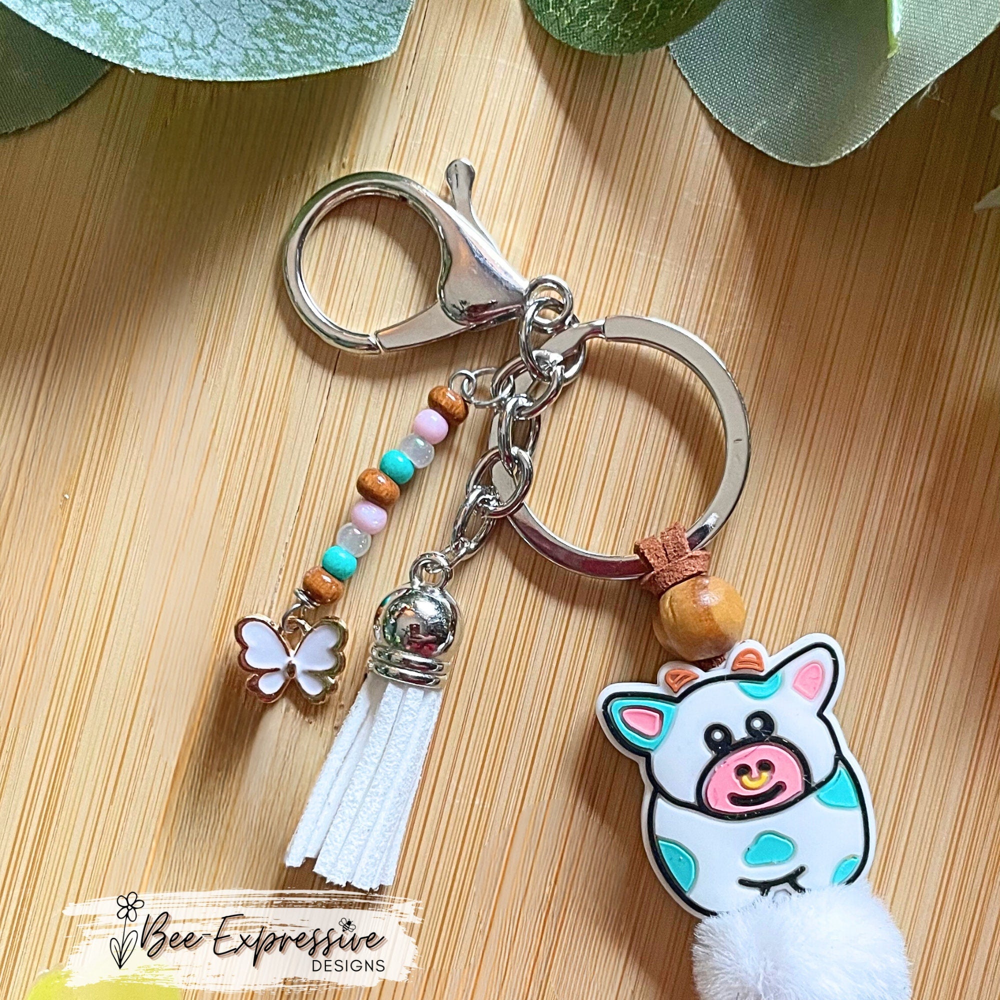 Adorable, handmade, bull cow keychain! Turquoise silicone lentil beads, wood beads, silicone round pink beads, beaded tassel with butterfly