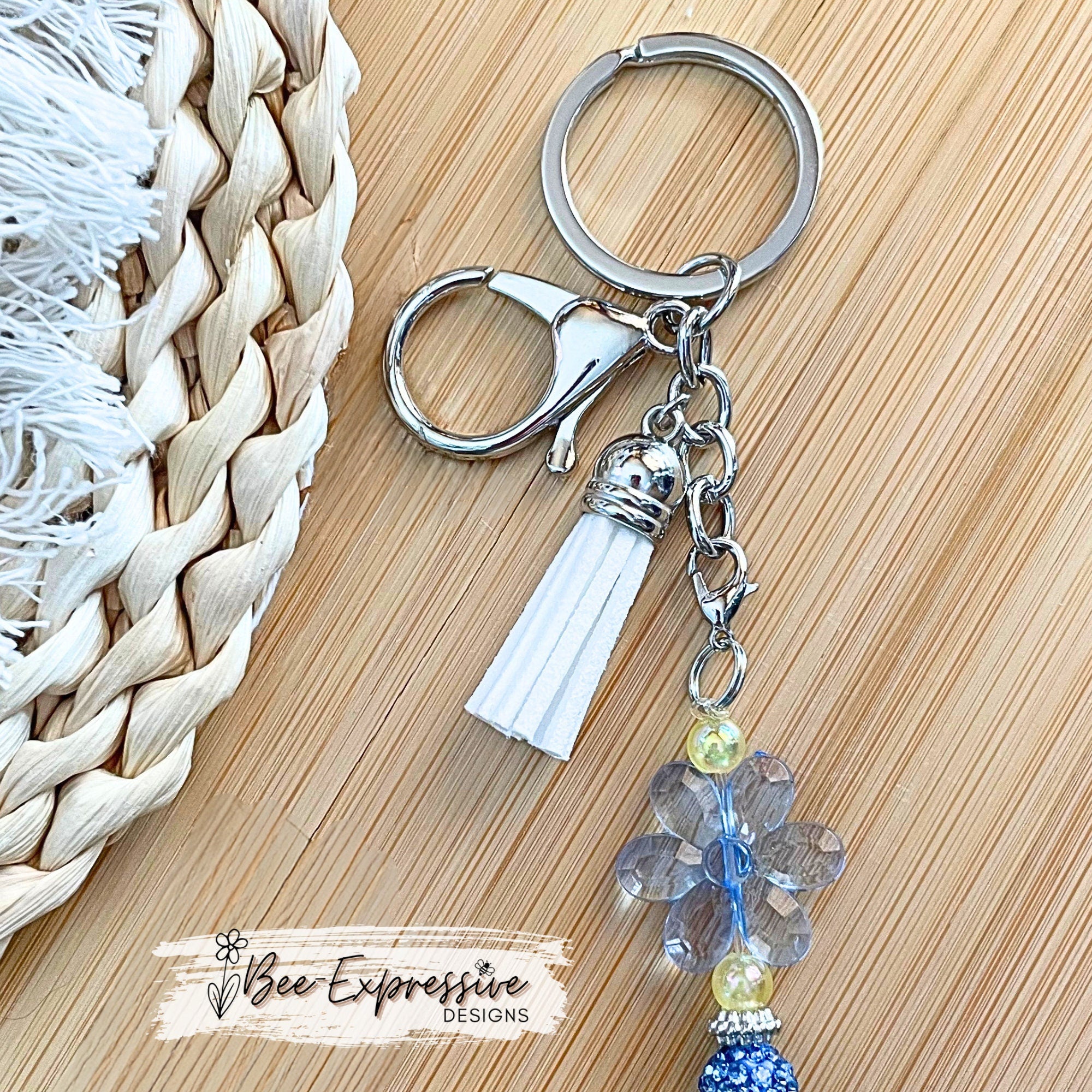 Beautiful, handmade keychain with blue transparent acrylic flower beads and rhinestones and butterfly charm