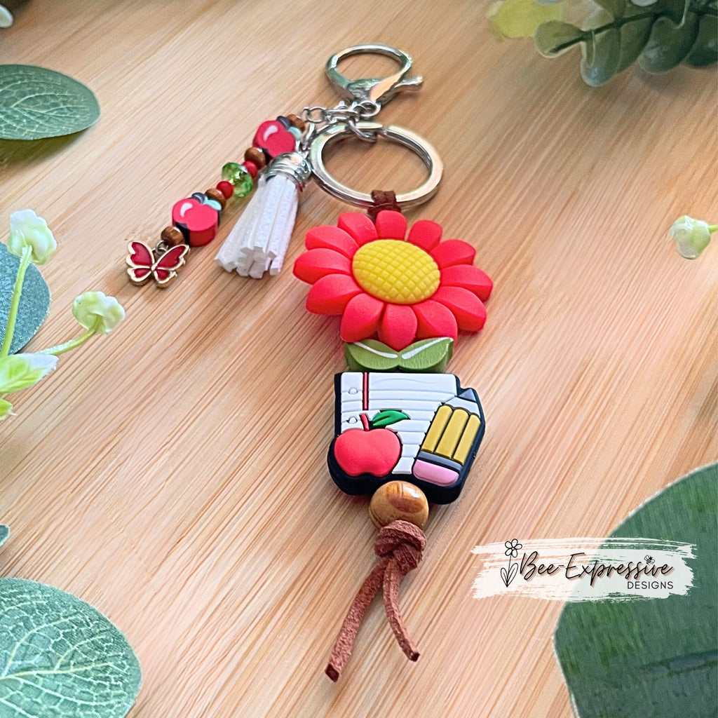 Handmade, cute, TEACHER keychain!  Lobster claw clasp, brown suede cord, daisy focal bead, beaded tassel, clay apple beads, butterfly charm