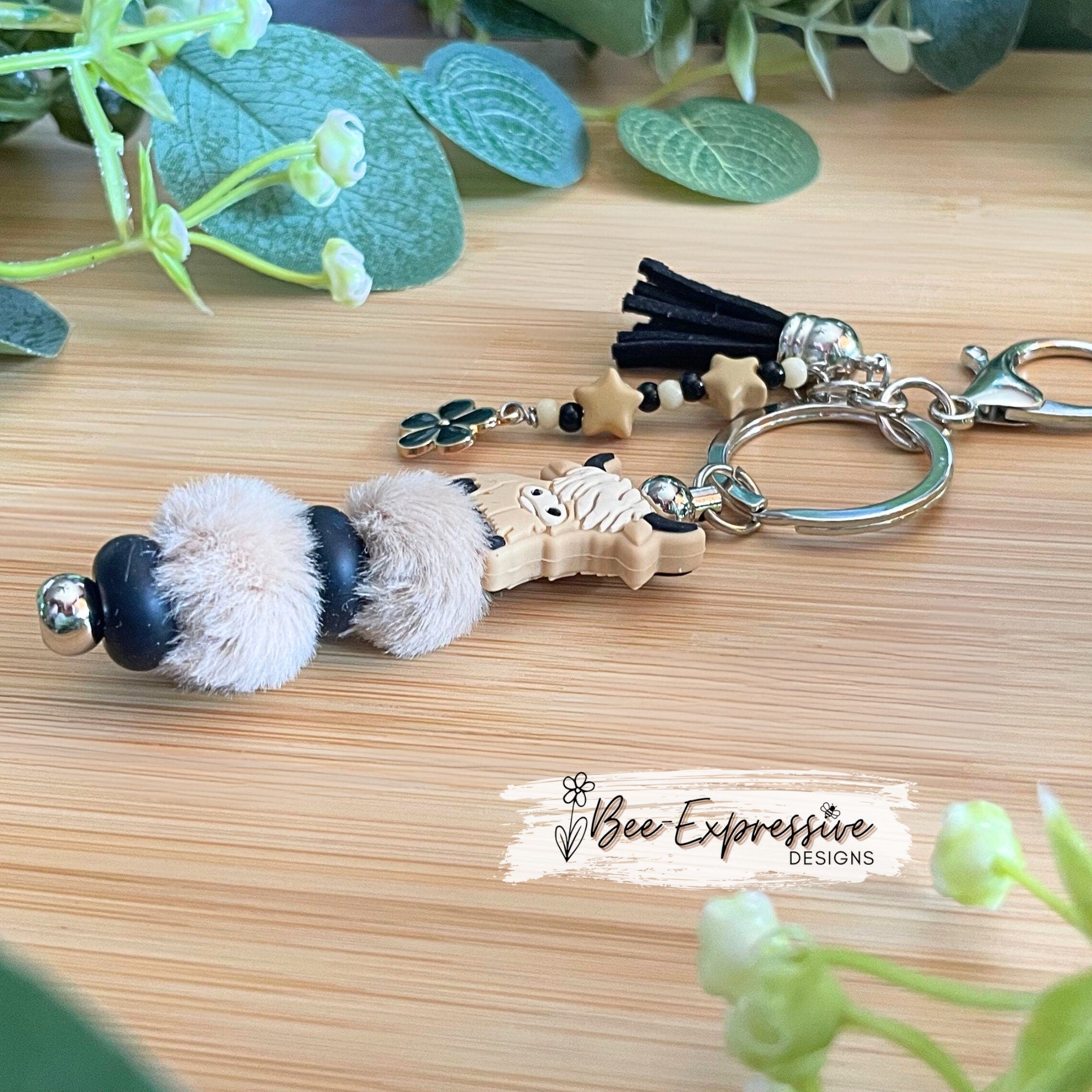 Adorable, handmade, bull cow keychain! Furry beads, silicone lentil spacers, stars, acrylic beaded tassel and black flower charm!