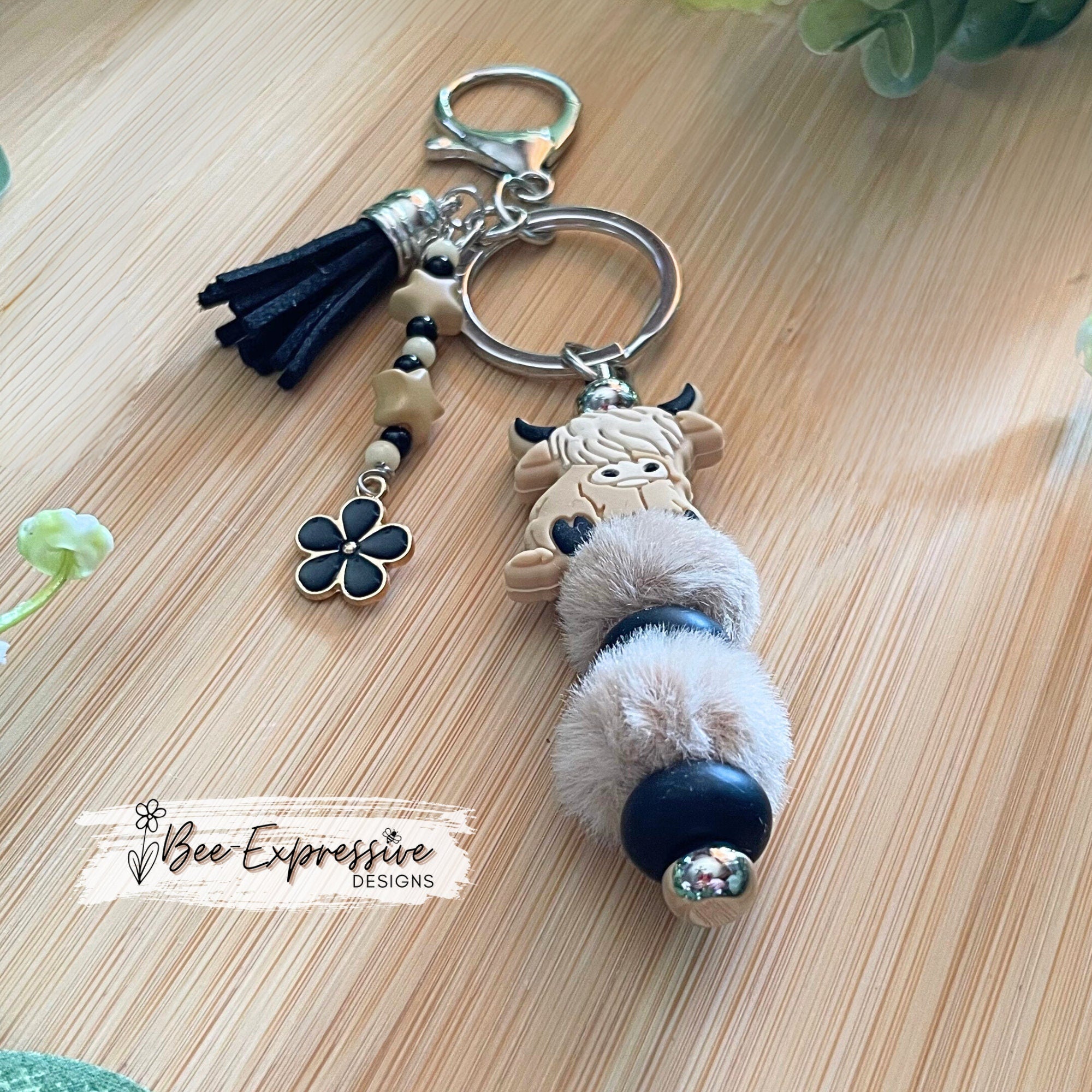 Adorable, handmade, bull cow keychain! Furry beads, silicone lentil spacers, stars, acrylic beaded tassel and black flower charm!