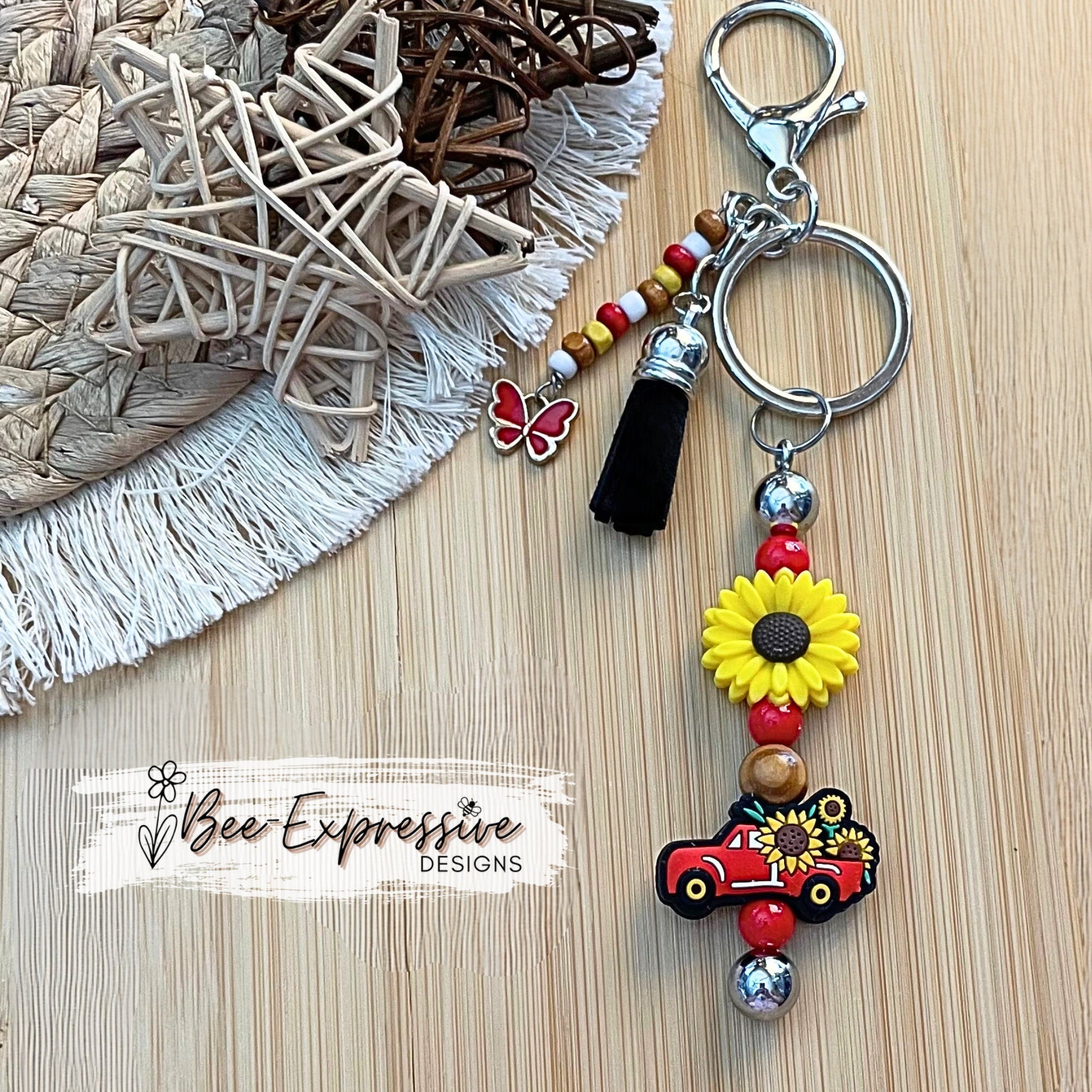 Beaded, silicone sunflower and red truck keychain! Lobster clasp with keyring, acrylic and wood beads, beaded tassel and a butterfly charm!
