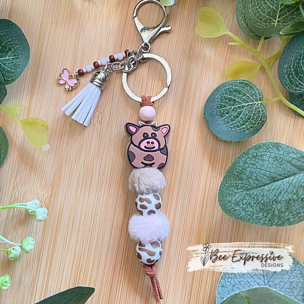 Beaded, COW keychain! Lobster or swivel clasp, furry beads, animal print silicone beads, acrylic beaded tassel with pink butterfly charm!