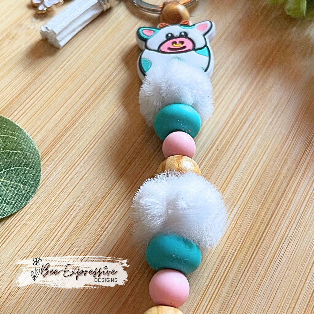 Adorable, handmade, bull cow keychain! Turquoise silicone lentil beads, wood beads, silicone round pink beads, beaded tassel with butterfly