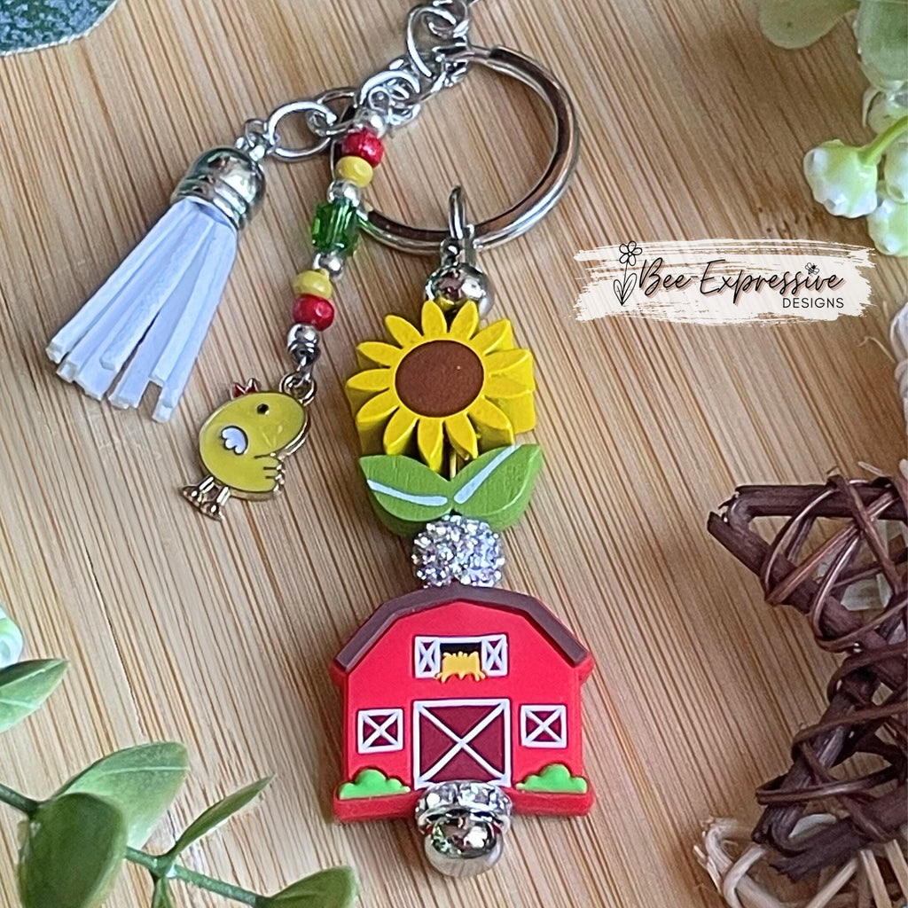 Handmade, vividly colored, farm barn keychain!  Lobster clasp, wood sunflower, silicone barn, beaded tassel with chicken charm, rhinestone