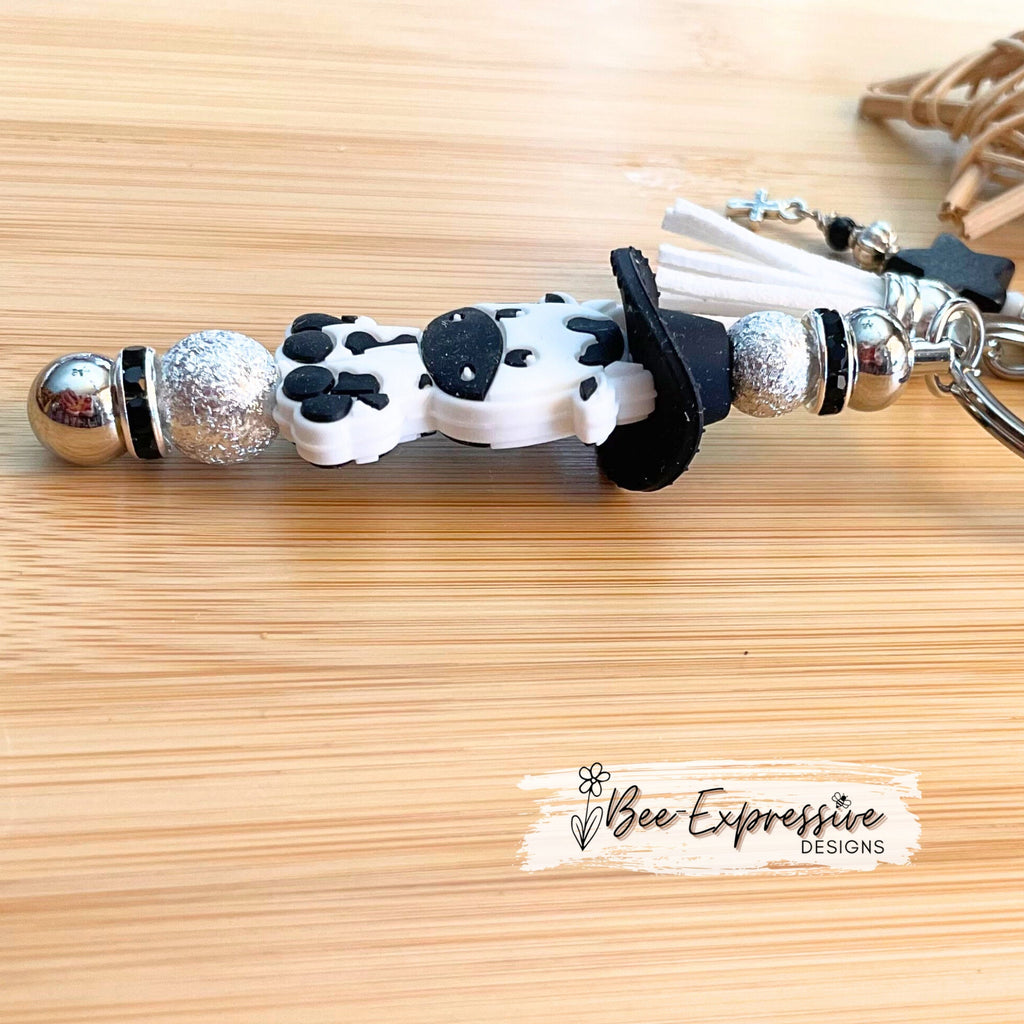 Handmade, ADORABLE, silicone COW with cowboy hat keychain! Lobster claw clasp, rhinestone spacers, beaded tassel w/ wood star & cross charm