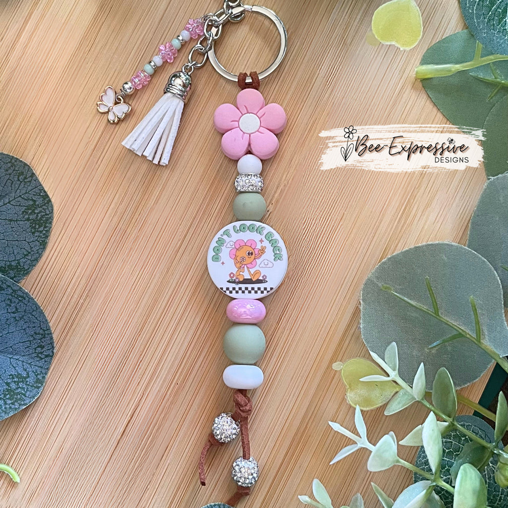 Handmade unique keychain with “Don’t look back” focal bead! Lobster clasp, suede cord, silicone beads, beaded tassel with butterfly charm