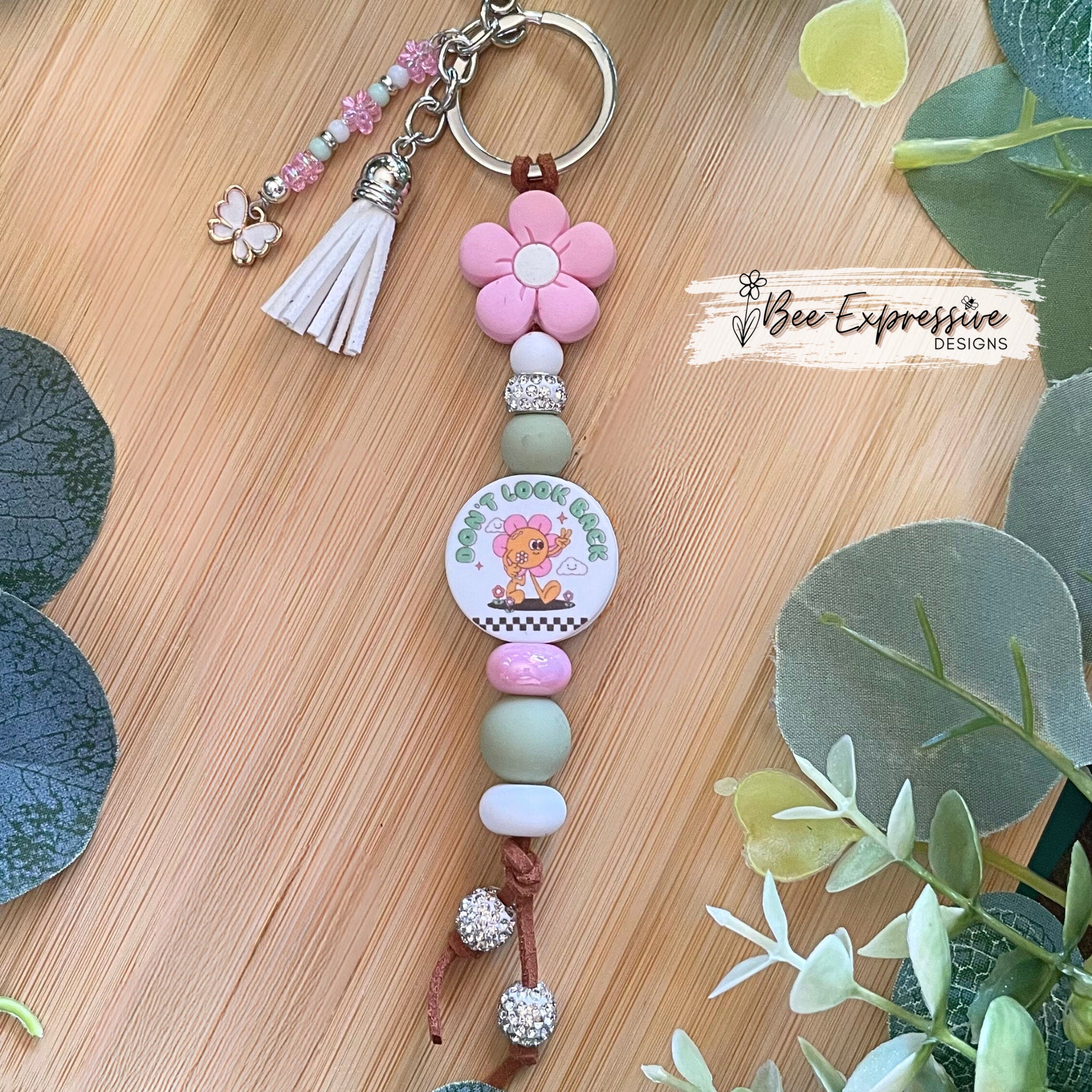 Handmade unique keychain with “Don’t look back” focal bead! Lobster clasp, suede cord, silicone beads, beaded tassel with butterfly charm