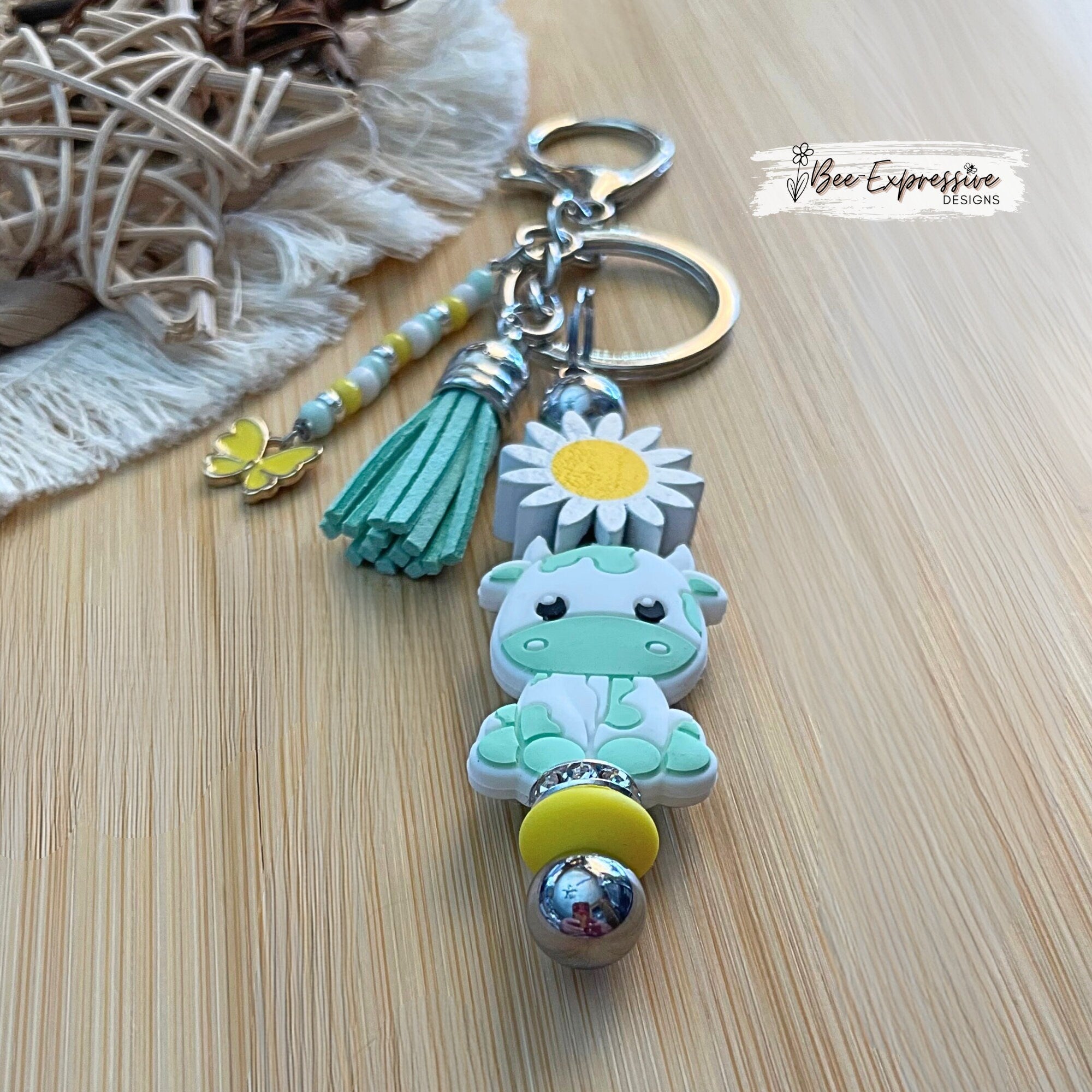 Handmade,  turquoise cow/bull keychain with wood sunflower!  Lobster claw clasp and metal bar, beaded tassel with butterfly charm!