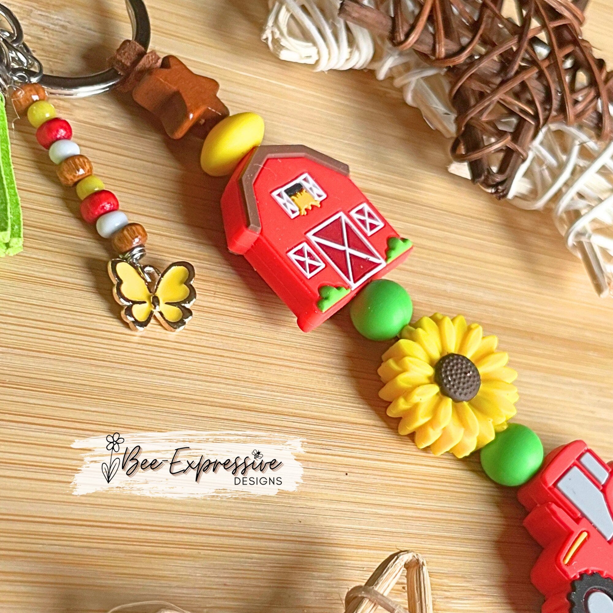 Handmade, vividly colored, farm tractor with barn keychain! Lobster clasp on suede cord, beaded tassel with sunflower, with butterfly charm!