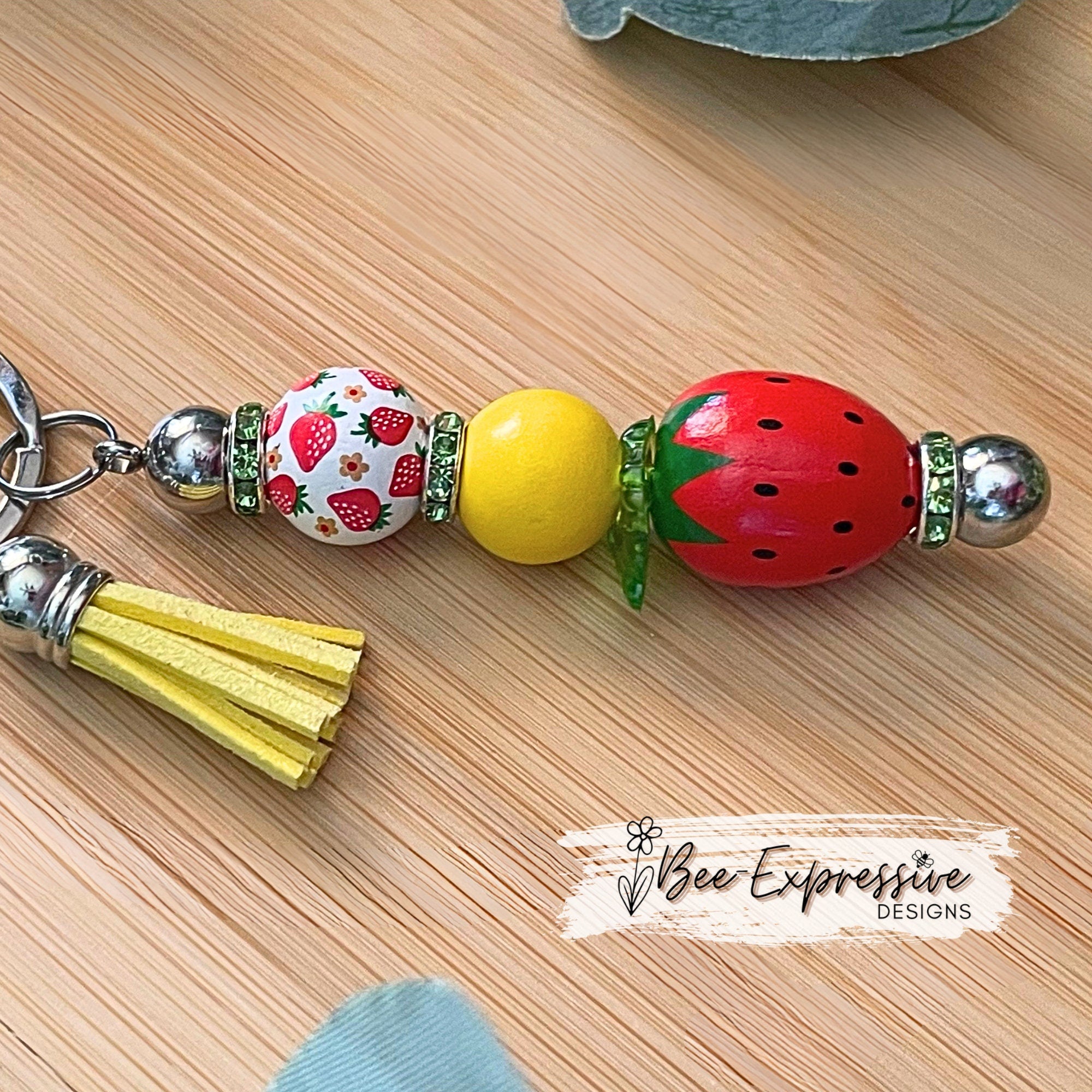 Adorable, strawberry beaded keychain!  Interchangeable beaded bar, lobster clasp, tassel, & butterfly charm! Comes with an acrylic leaf too!