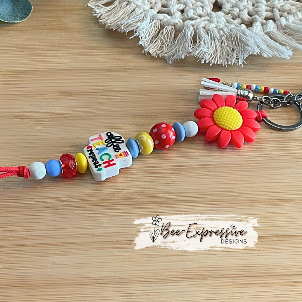 Handmade, cute, TEACHER keychain! Lobster or swivel clasp, red suede cord, daisy flower bead, beaded tassel with an apple charm pendant