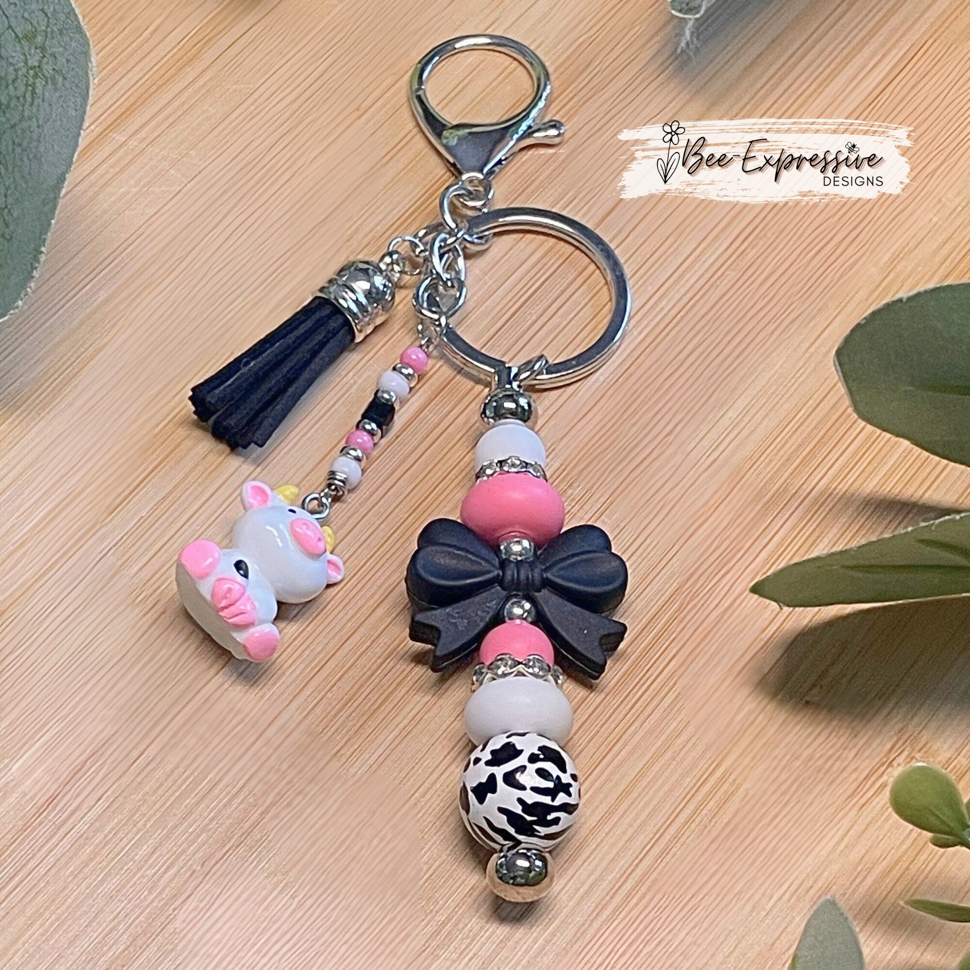 Adorable, handmade cow/bull keychain!  Lobster claw clasp, silicone bow, beaded tassel, cow charm, rhinestones, lentils, silver beads
