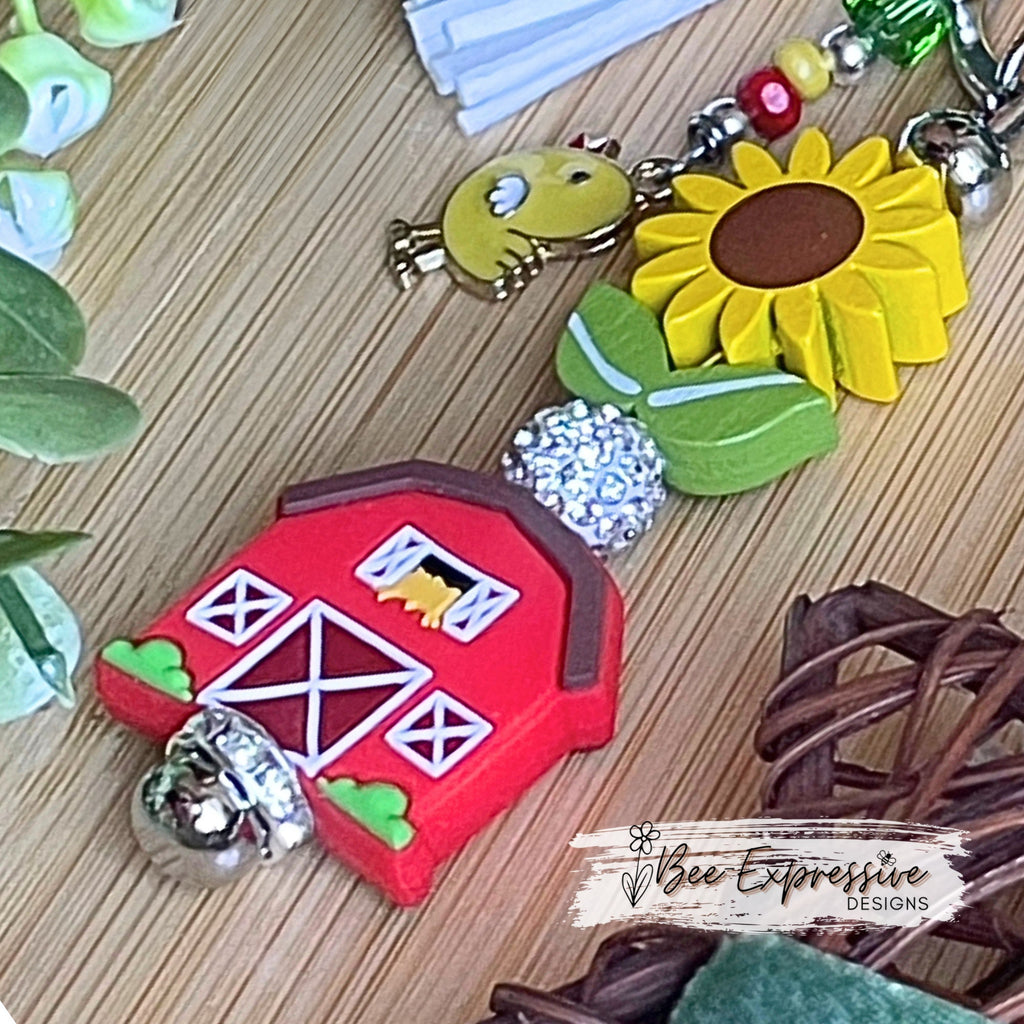 Handmade, vividly colored, farm barn keychain!  Lobster clasp, wood sunflower, silicone barn, beaded tassel with chicken charm, rhinestone
