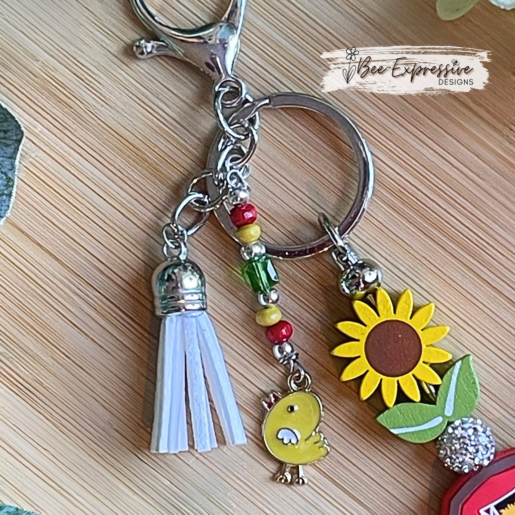 Handmade, vividly colored, farm barn keychain!  Lobster clasp, wood sunflower, silicone barn, beaded tassel with chicken charm, rhinestone
