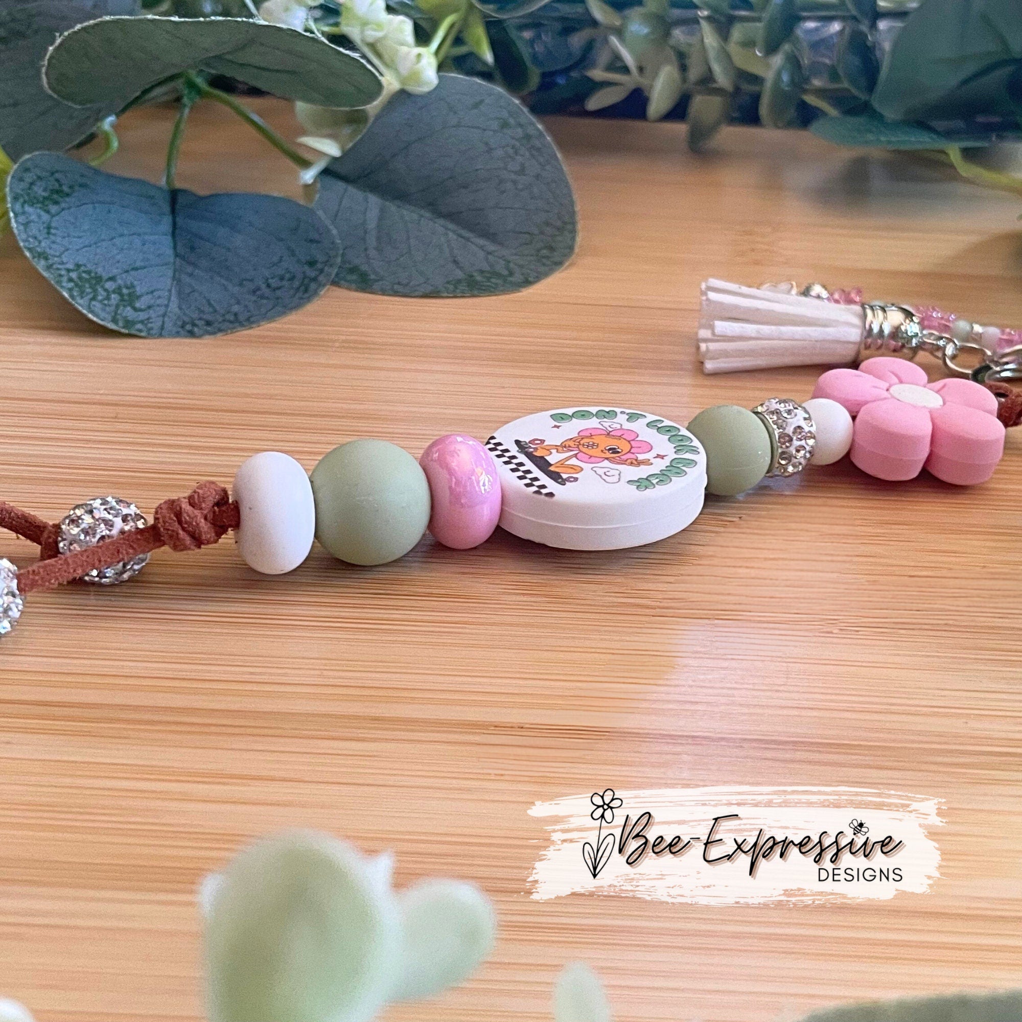 Handmade unique keychain with “Don’t look back” focal bead! Lobster clasp, suede cord, silicone beads, beaded tassel with butterfly charm