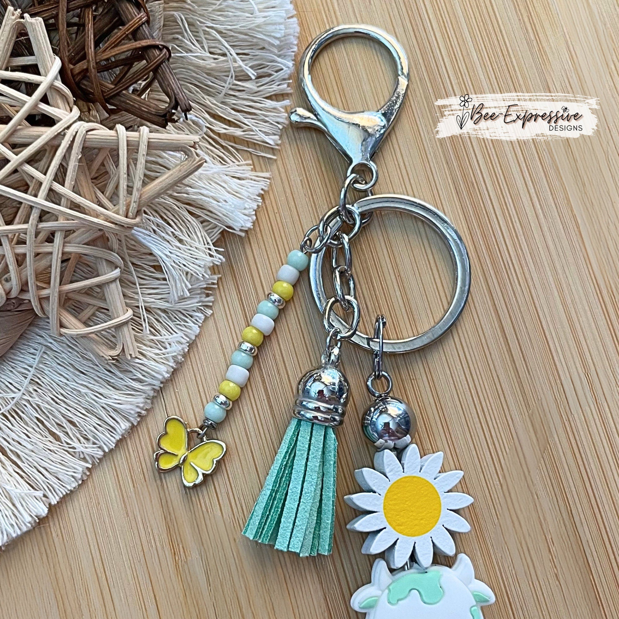 Handmade,  turquoise cow/bull keychain with wood sunflower!  Lobster claw clasp and metal bar, beaded tassel with butterfly charm!