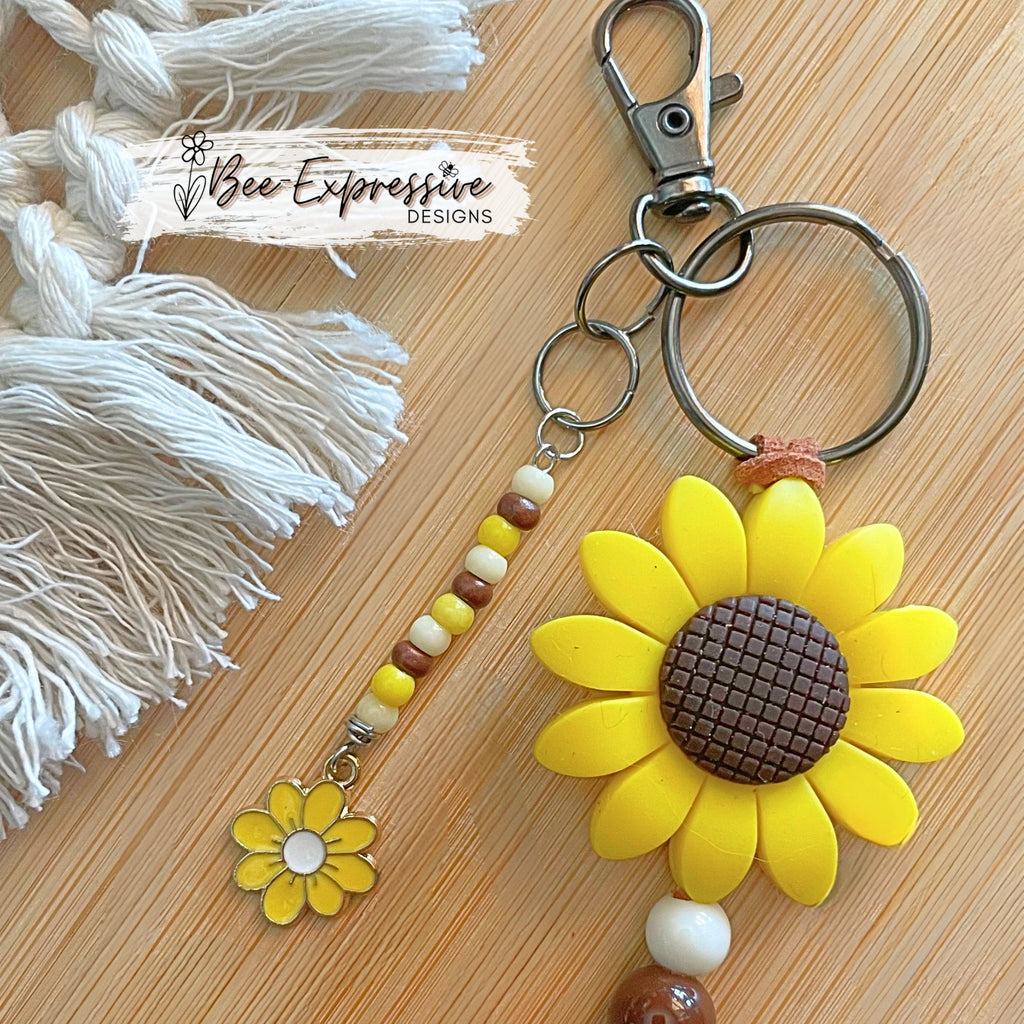 Handmade, unique, silicone sunflower gnome keychain!  Lobster clasp, suede cord, wood beads, beaded tassel with yellow daisy charm!
