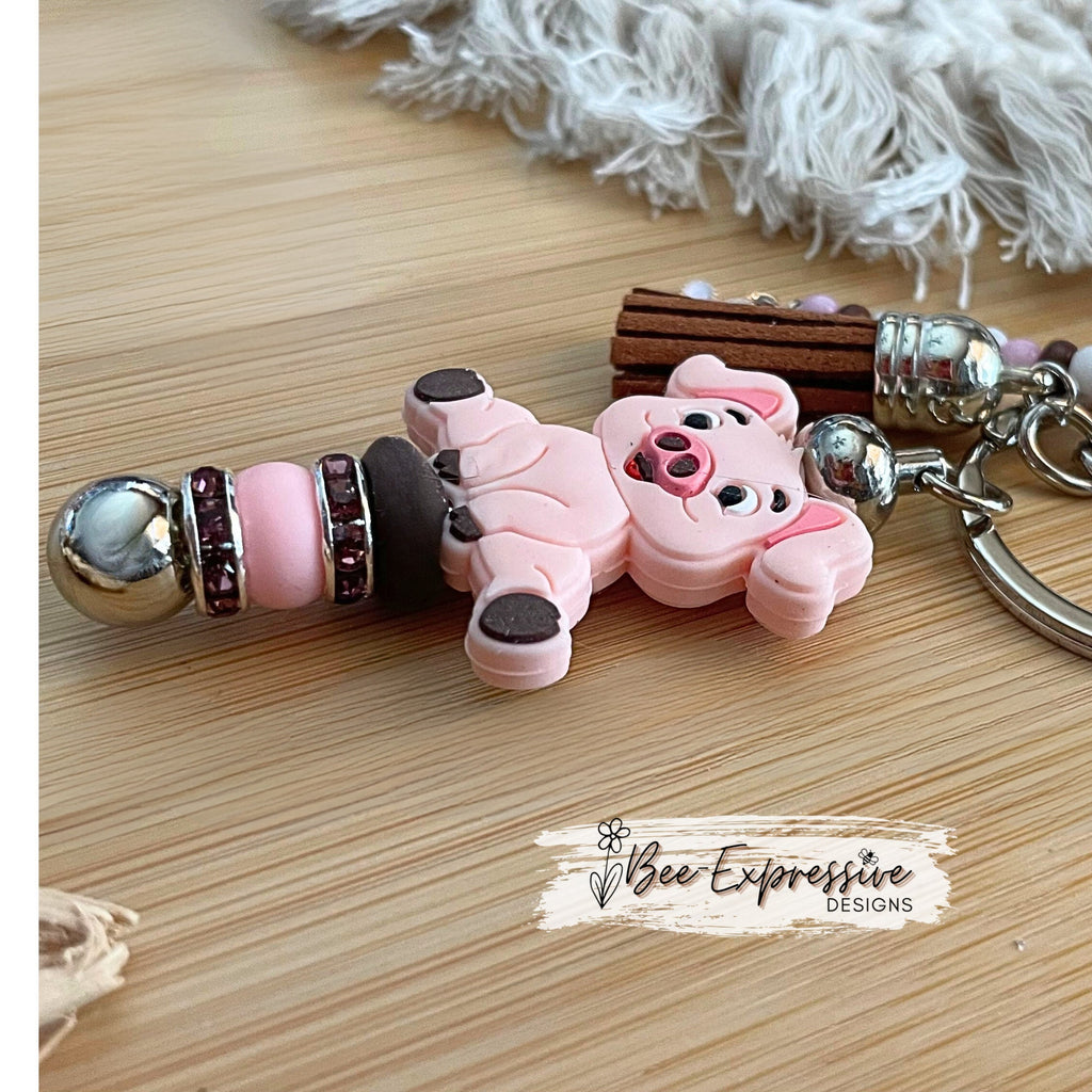 Adorable, handmade, pink pig metal keychain! Lobster claw clasp, rhinestone spacers, silicone lentils, beaded tassel with heart charm
