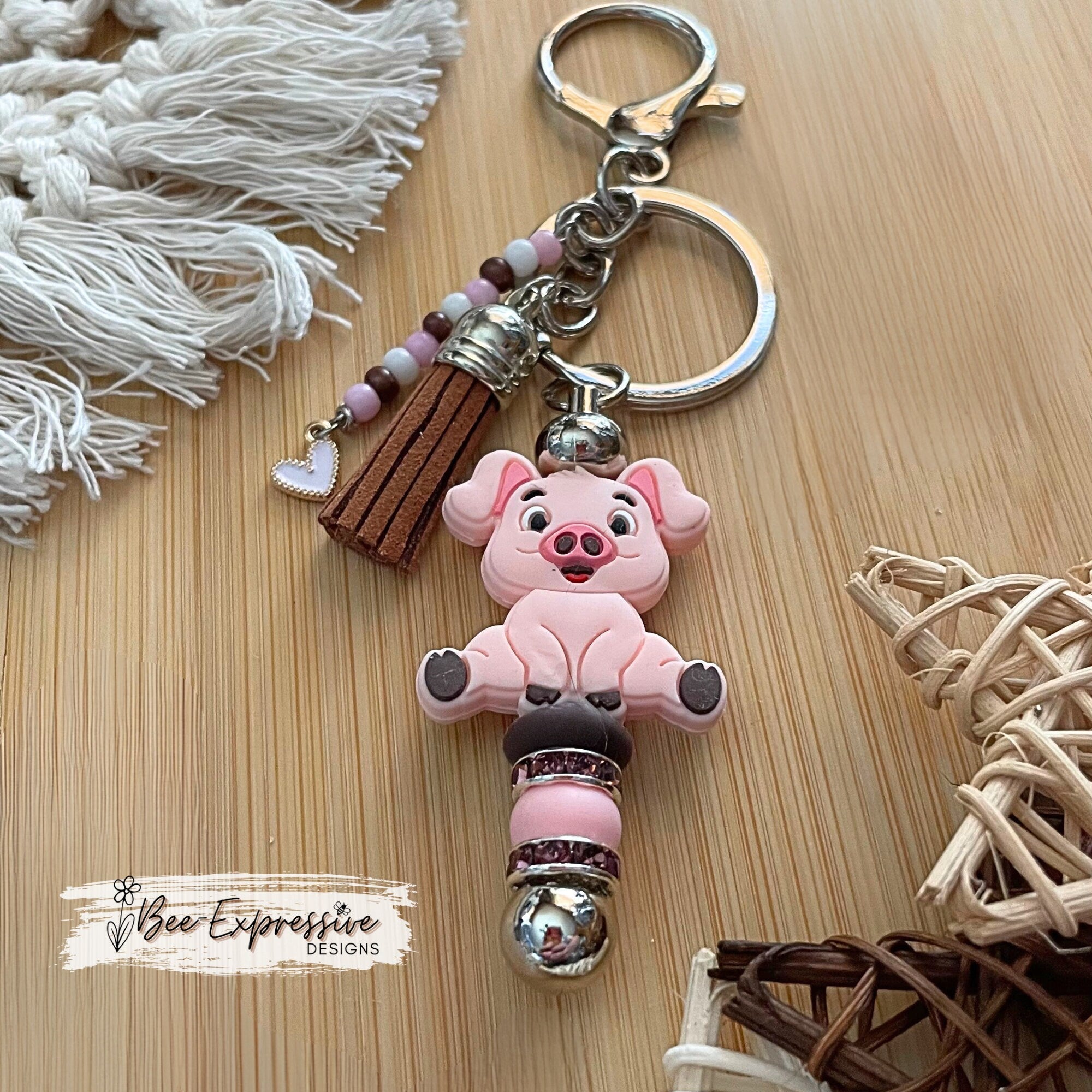 Adorable, handmade, pink pig metal keychain! Lobster claw clasp, rhinestone spacers, silicone lentils, beaded tassel with heart charm