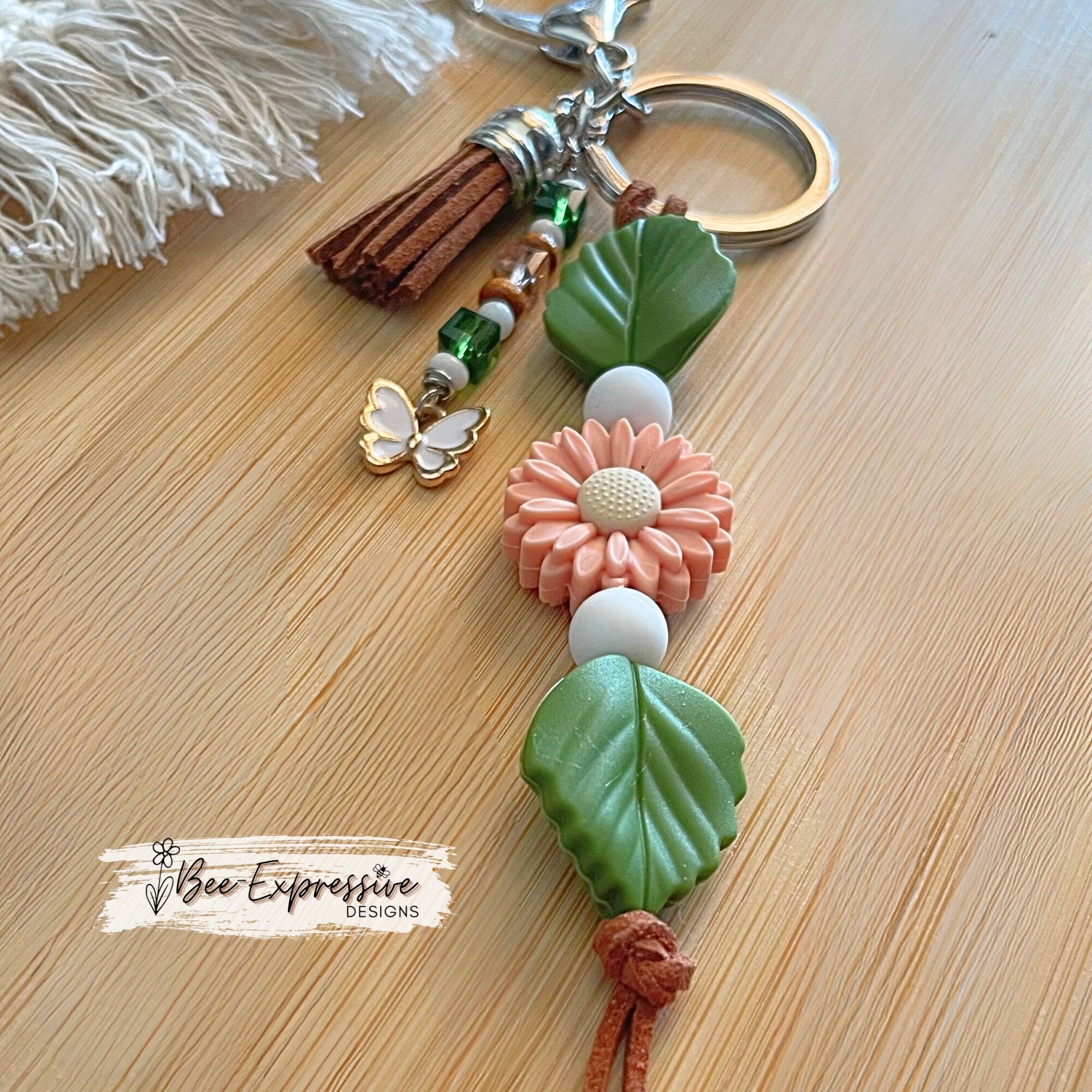 Beautiful handmade silicone DAISY floral keychain!  Lobster claw, suede cord, rubber leaves & a beaded tassel with butterfly charm