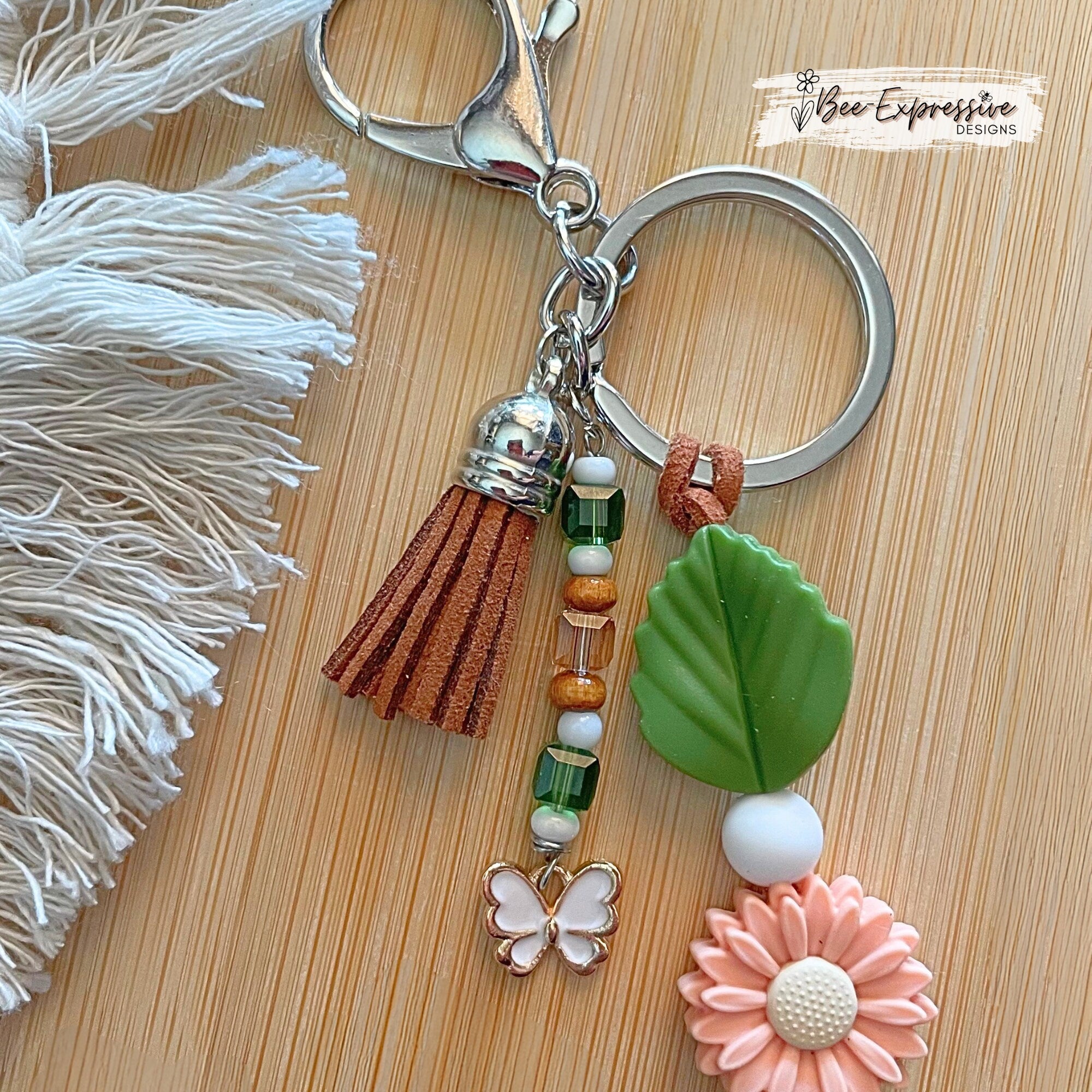Beautiful handmade silicone DAISY floral keychain!  Lobster claw, suede cord, rubber leaves & a beaded tassel with butterfly charm