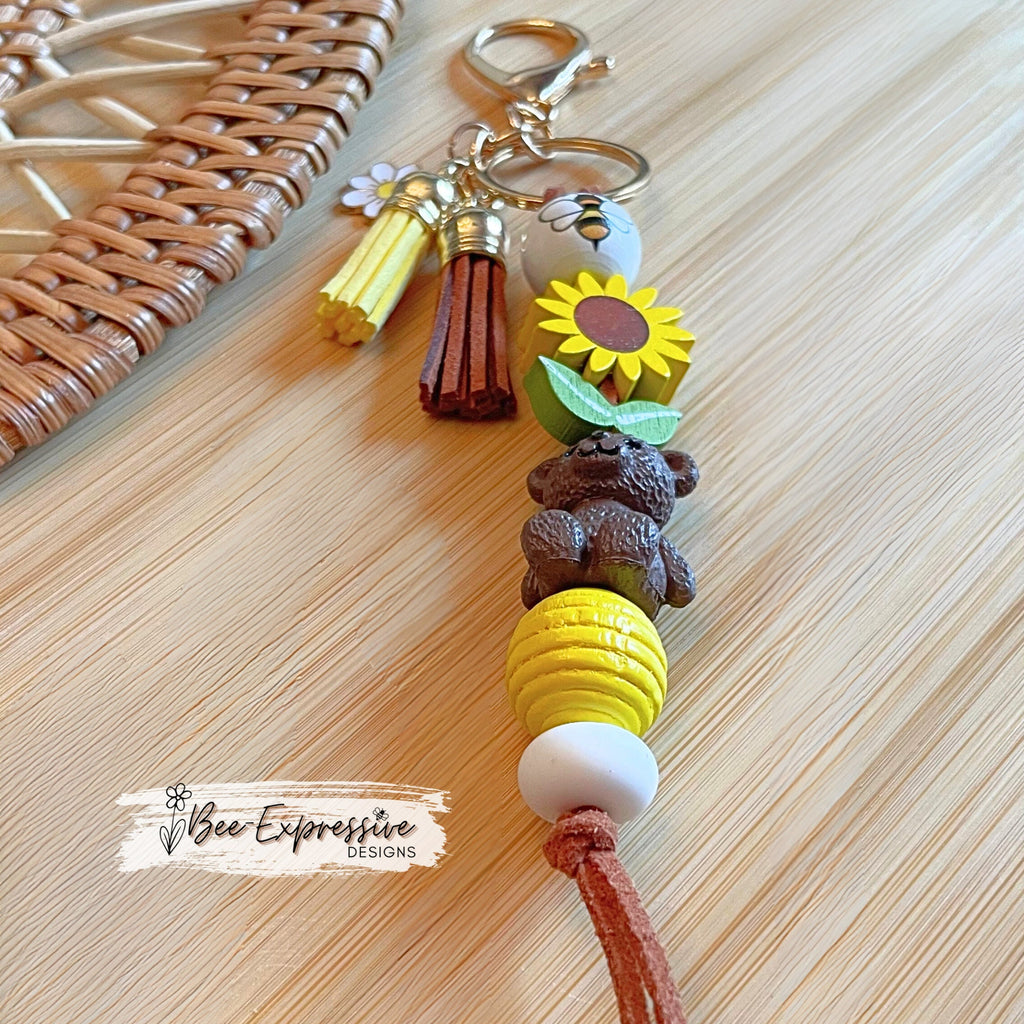 Handmade, adorable, honey bear bumble bee keychain! Lobster claw, corded, wood sunflower, bee bead, daisy charm pendant, tassels