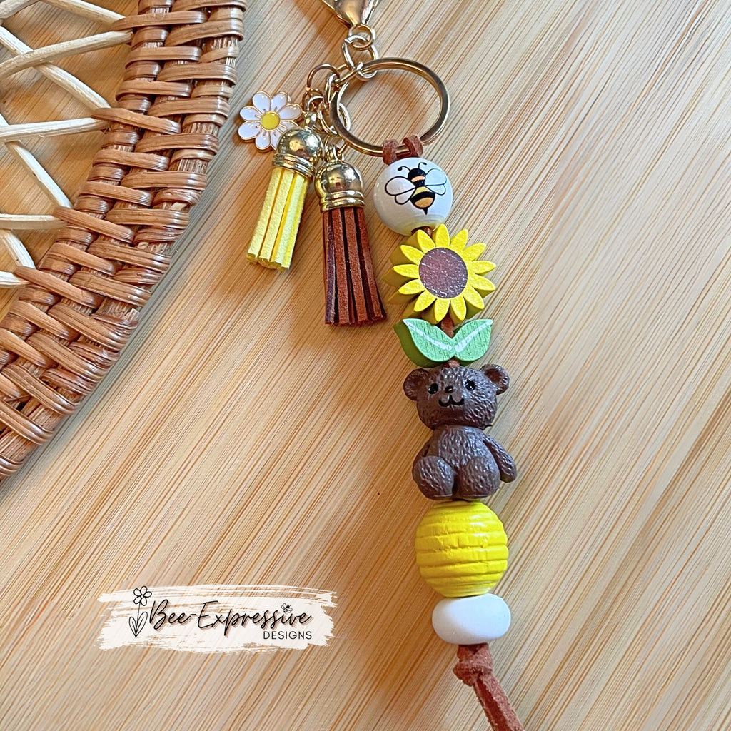 Handmade, adorable, honey bear bumble bee keychain! Lobster claw, corded, wood sunflower, bee bead, daisy charm pendant, tassels