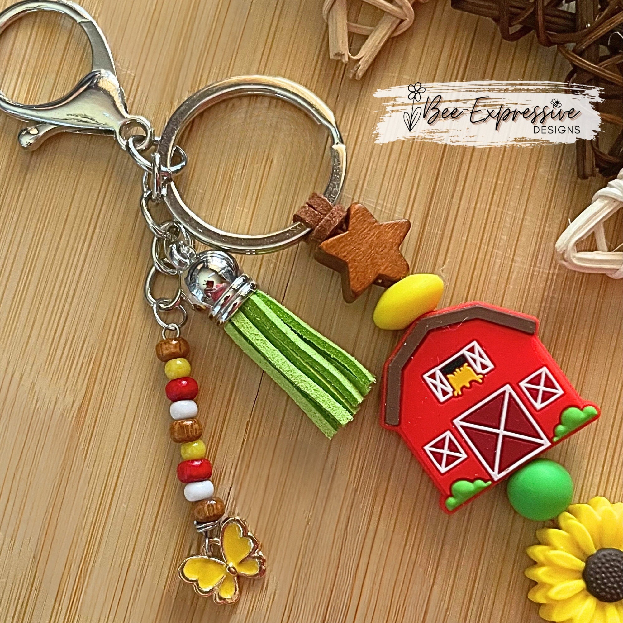 Handmade, vividly colored, farm tractor with barn keychain! Lobster clasp on suede cord, beaded tassel with sunflower, with butterfly charm!