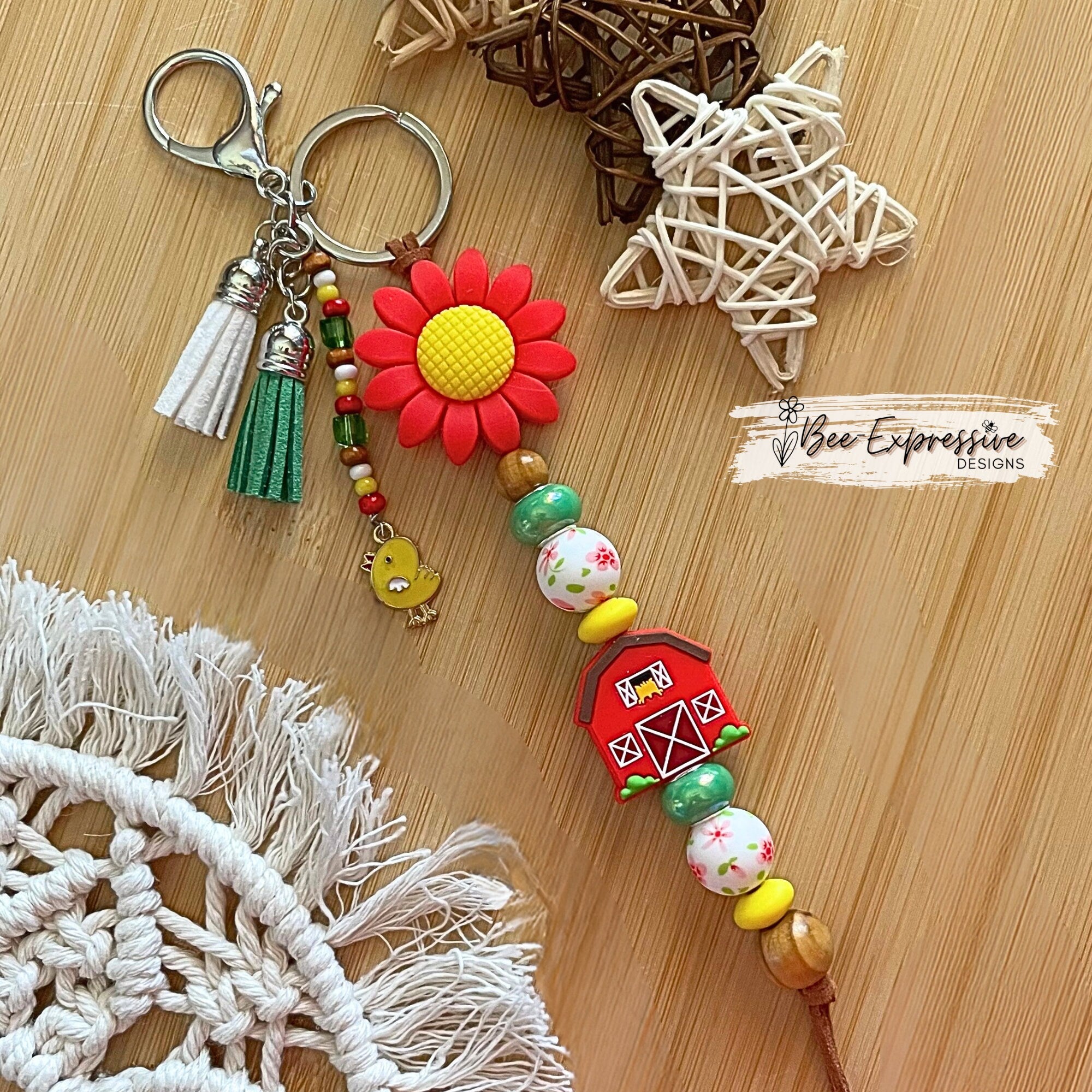 Handmade, vividly colored, silicone sunflower with barn keychain! Lobster clasp on suede cord, beaded tassel with chicken charm,