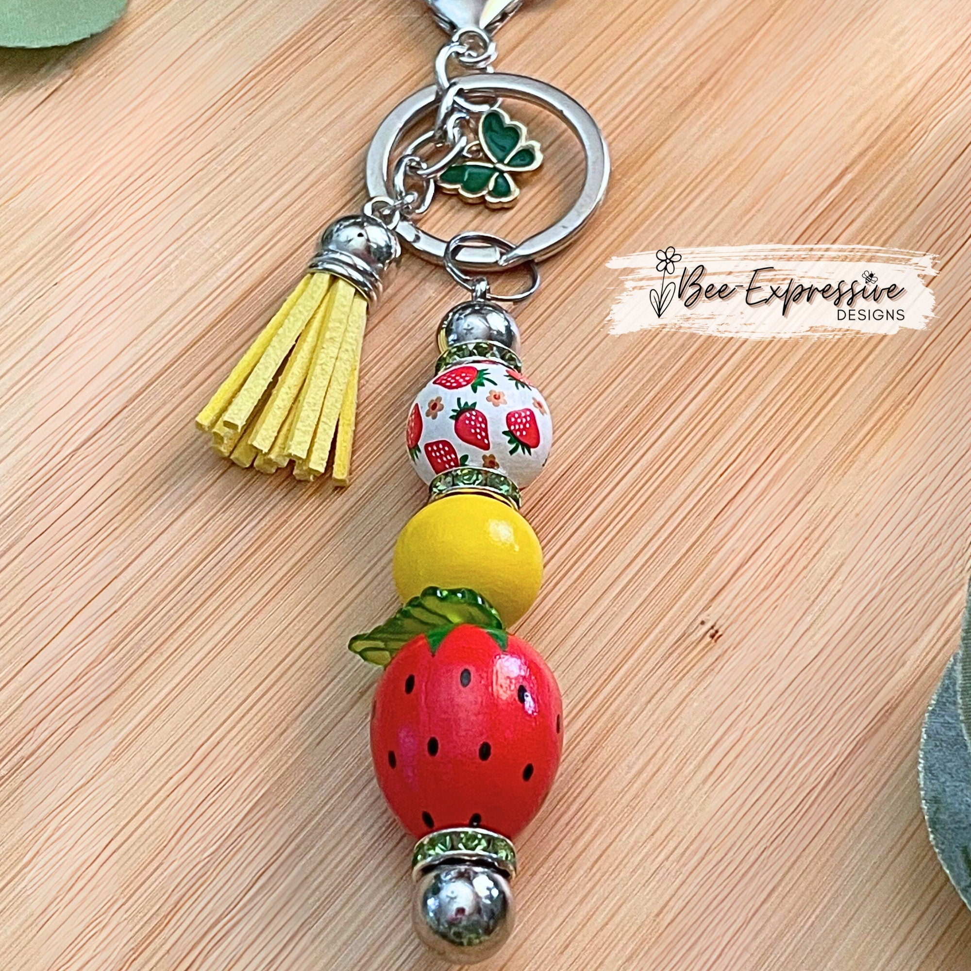 Adorable, strawberry beaded keychain!  Interchangeable beaded bar, lobster clasp, tassel, & butterfly charm! Comes with an acrylic leaf too!