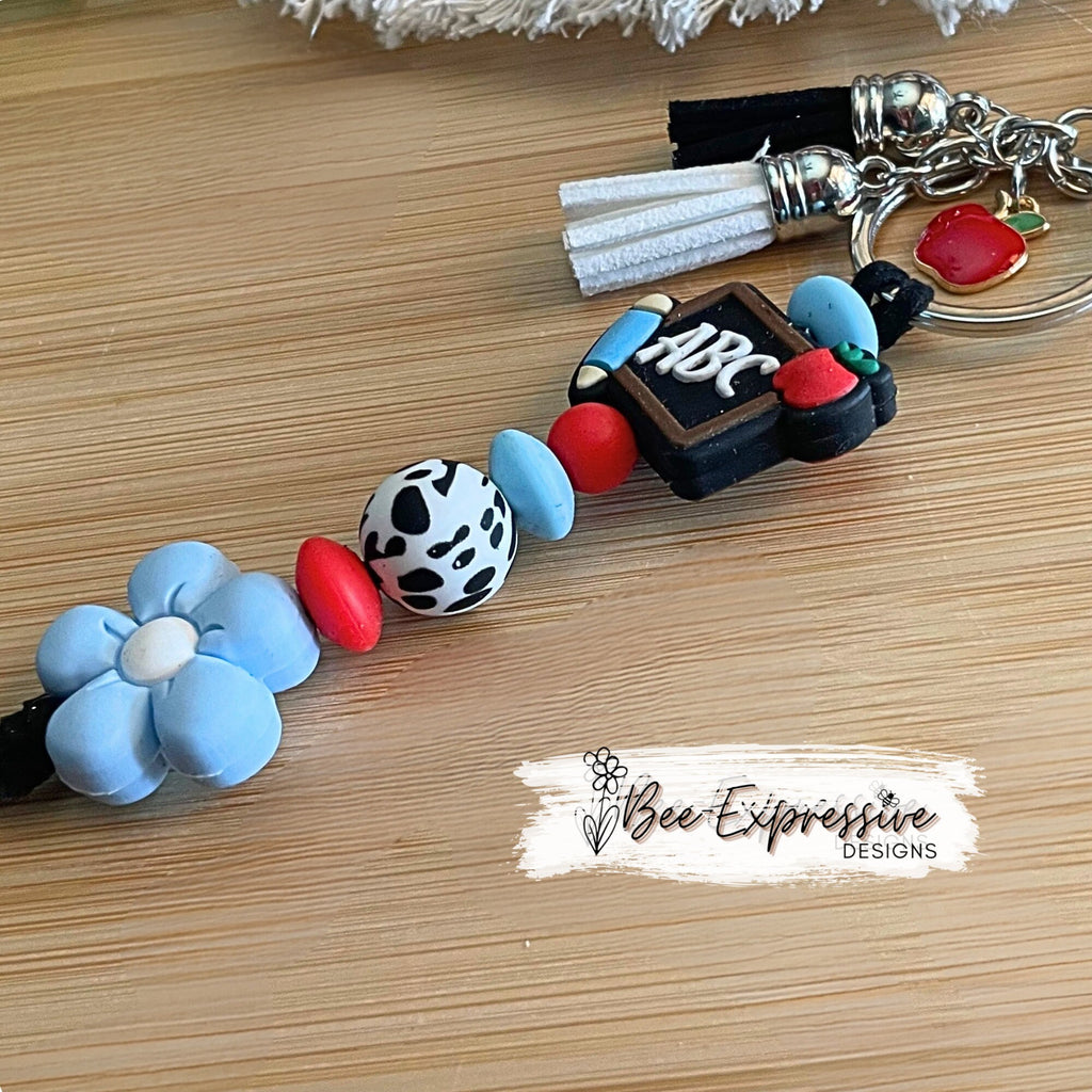 Handmade, cute, TEACHER keychain! Lobster claw clasp, black suede cord, silicone ABC chalkboard and daisy flower, an apple charm pendant!
