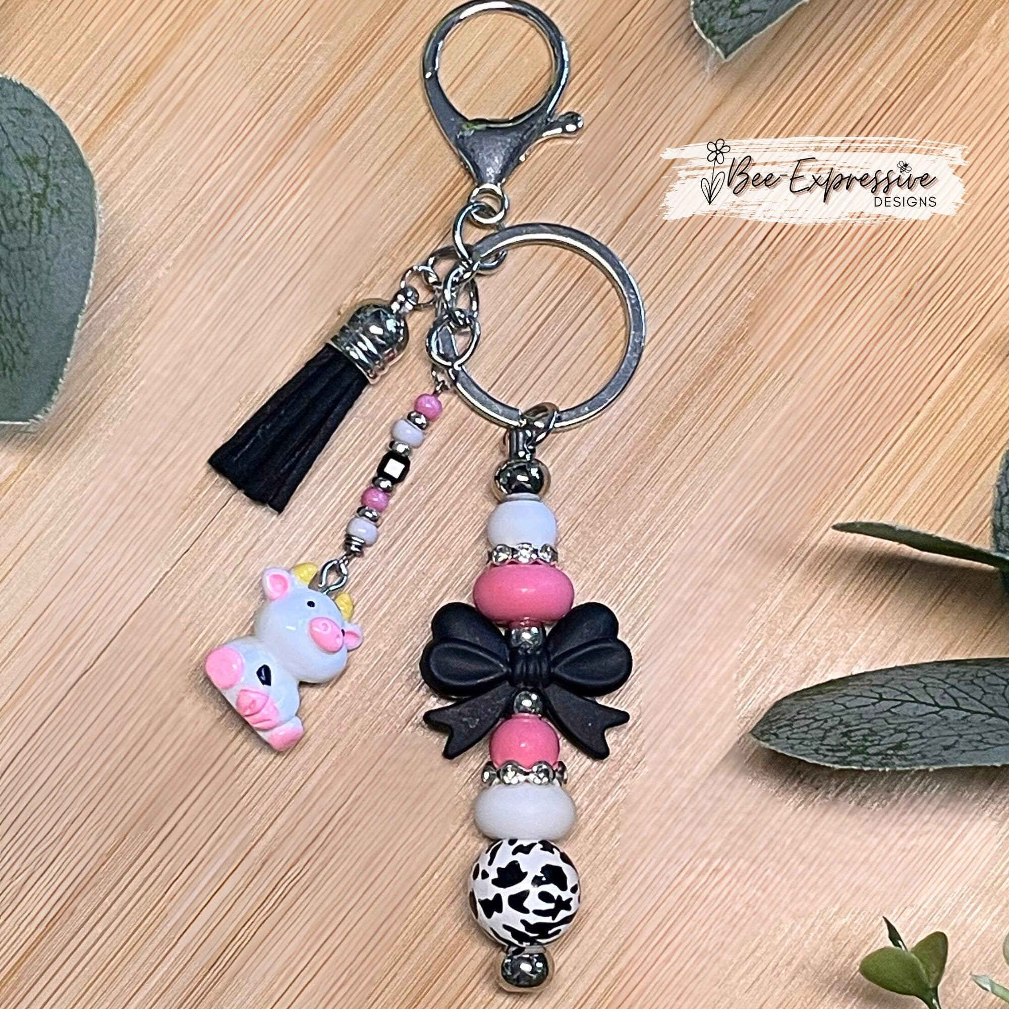 Adorable, handmade cow/bull keychain!  Lobster claw clasp, silicone bow, beaded tassel, cow charm, rhinestones, lentils, silver beads