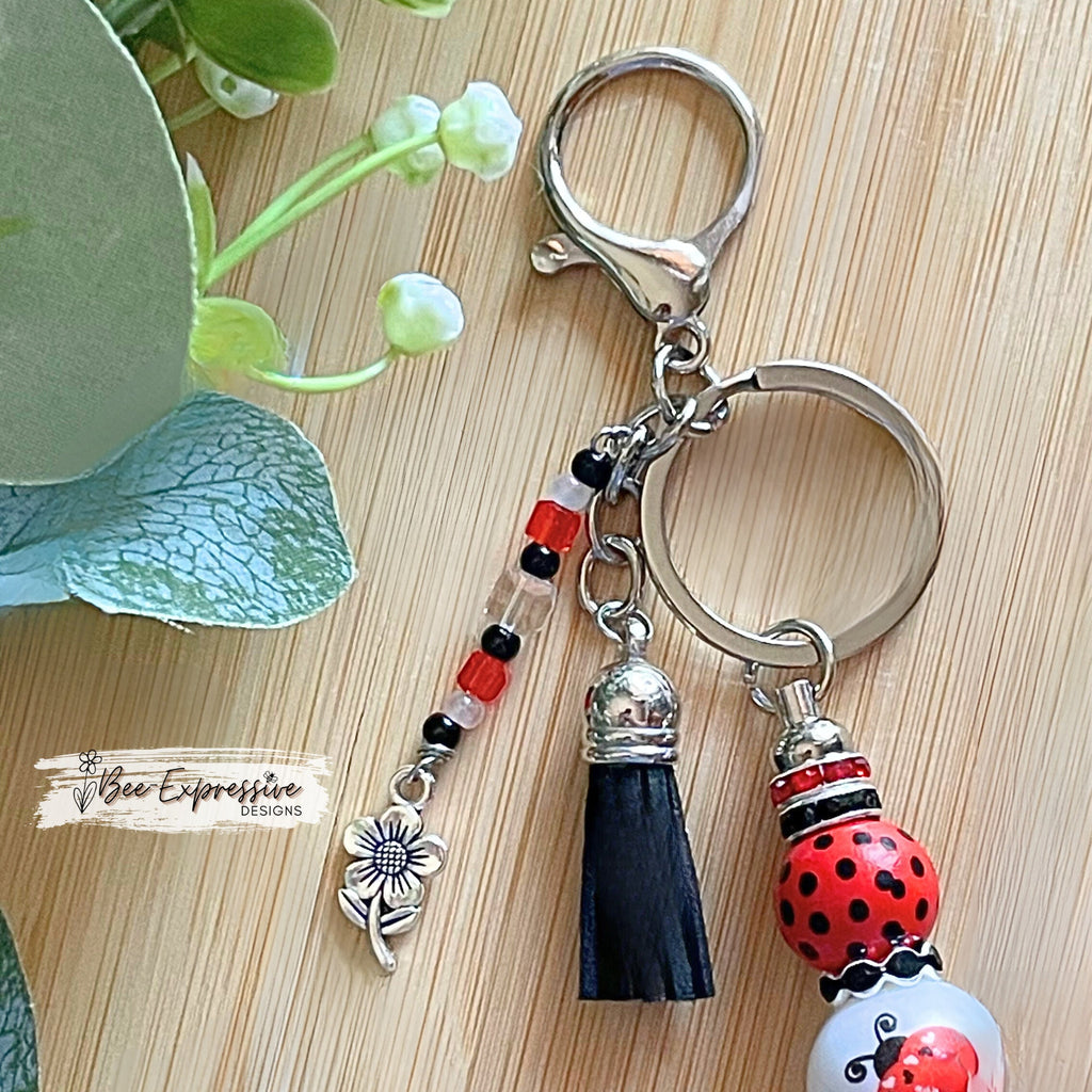 Handmade and unique, lady bug keychain!  Lobster claw clasp, wood printed beads, acrylic lady bug bead, rhinestones, flower charm pendant