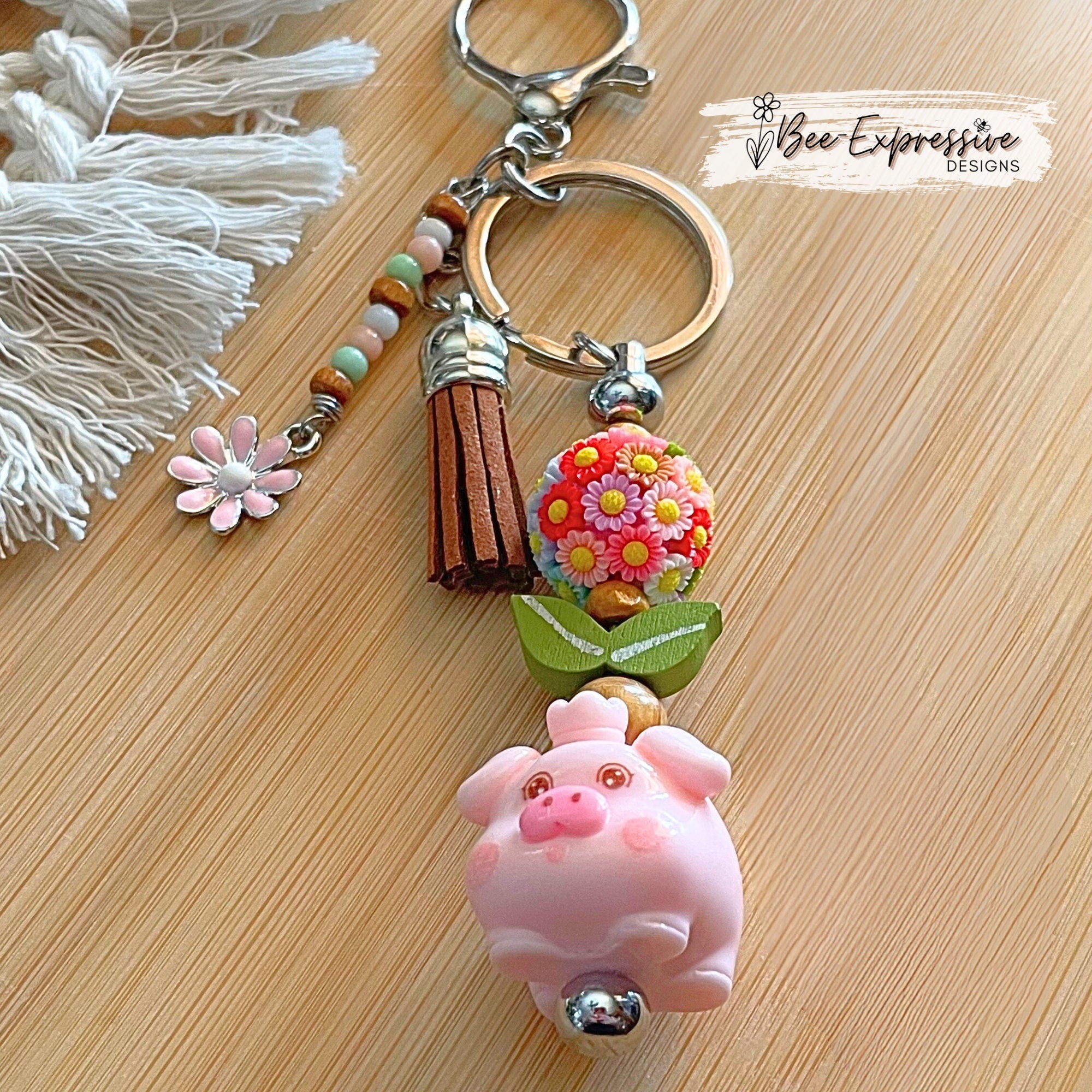 Adorable, handmade, pink pig metal keychain with multi floral bead!  Lobster claw clasp, bead bar, wood beads, beaded tasse pink daisy charm