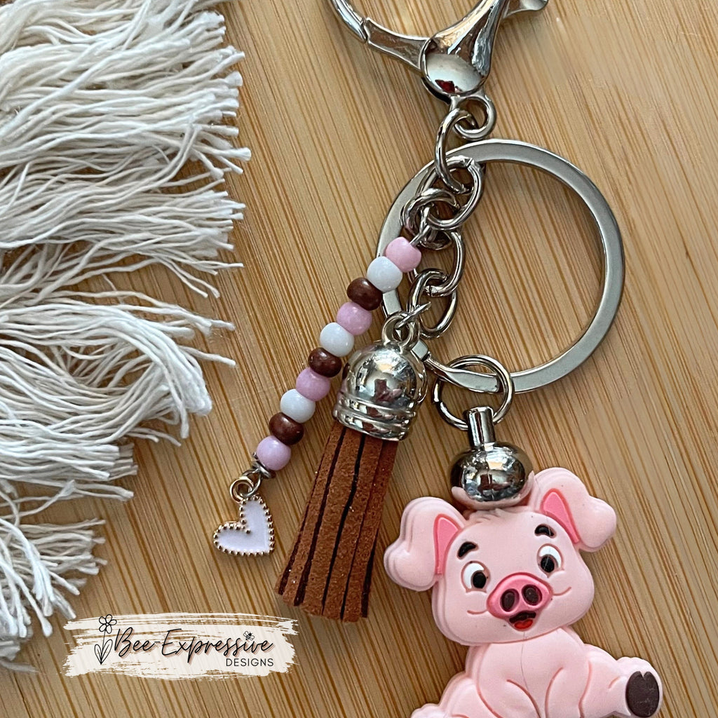 Adorable, handmade, pink pig metal keychain! Lobster claw clasp, rhinestone spacers, silicone lentils, beaded tassel with heart charm