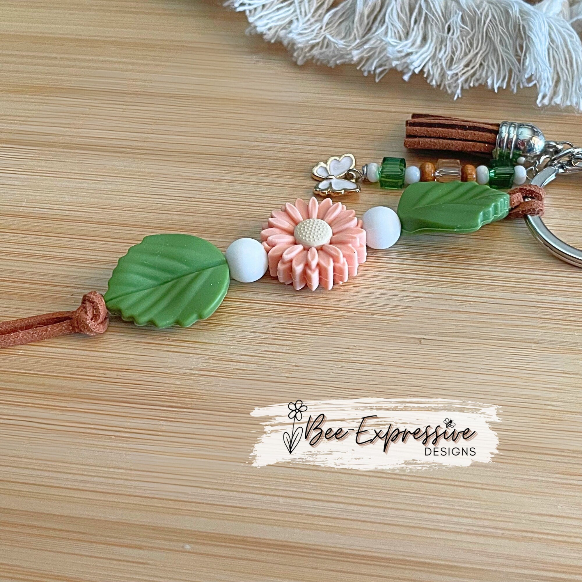 Beautiful handmade silicone DAISY floral keychain!  Lobster claw, suede cord, rubber leaves & a beaded tassel with butterfly charm