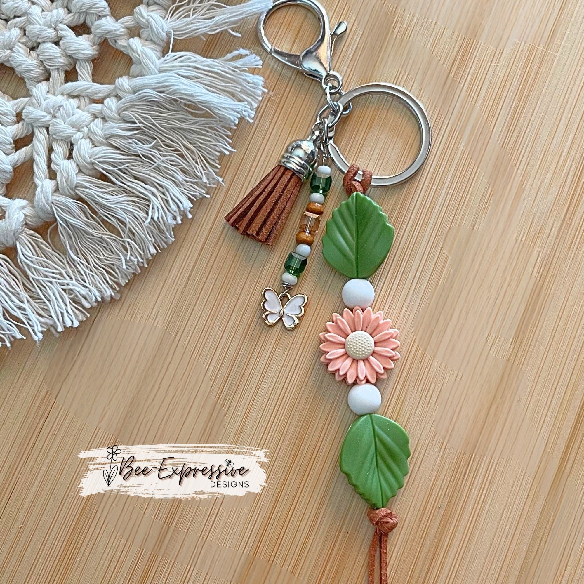 Beautiful handmade silicone DAISY floral keychain!  Lobster claw, suede cord, rubber leaves & a beaded tassel with butterfly charm
