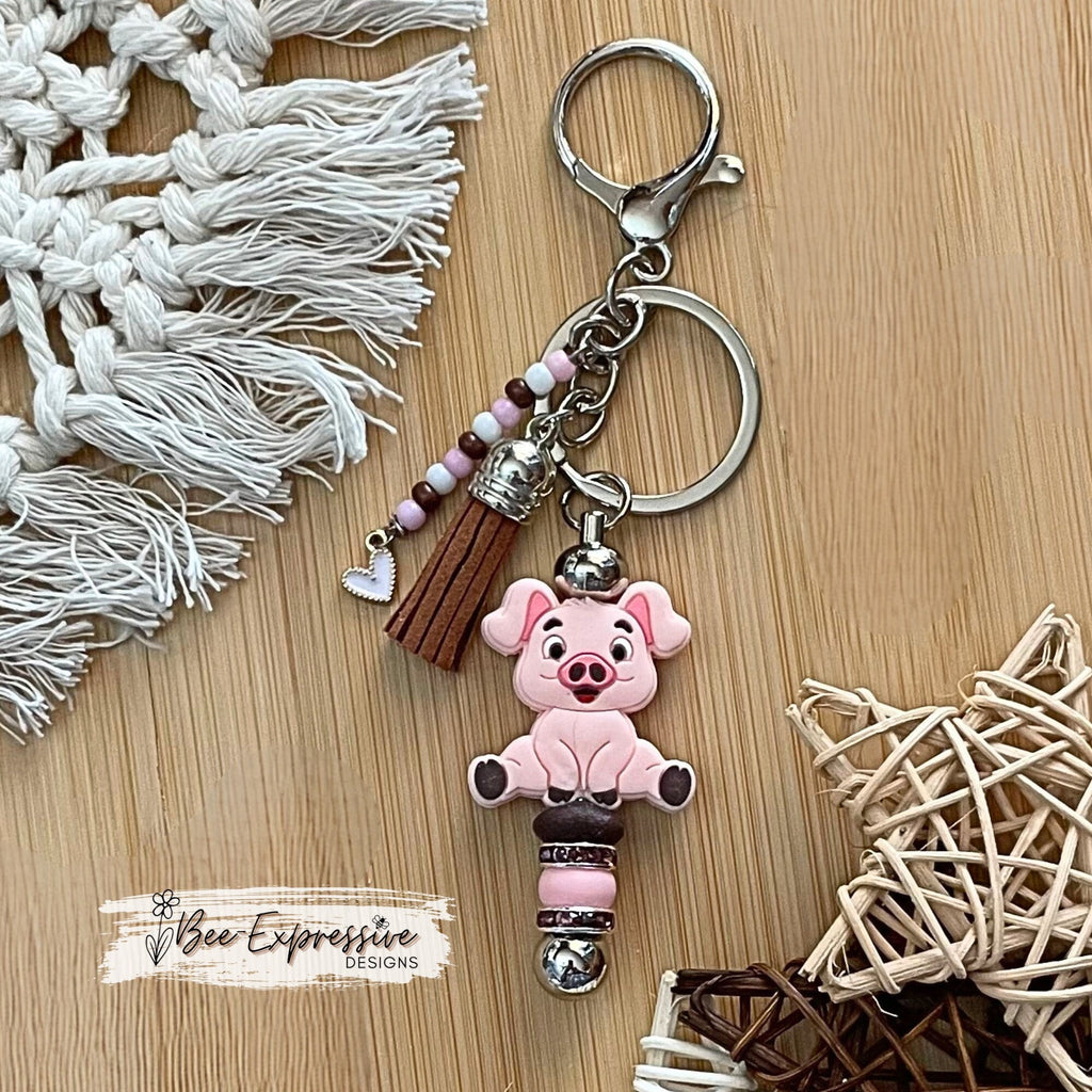 Adorable, handmade, pink pig metal keychain! Lobster claw clasp, rhinestone spacers, silicone lentils, beaded tassel with heart charm