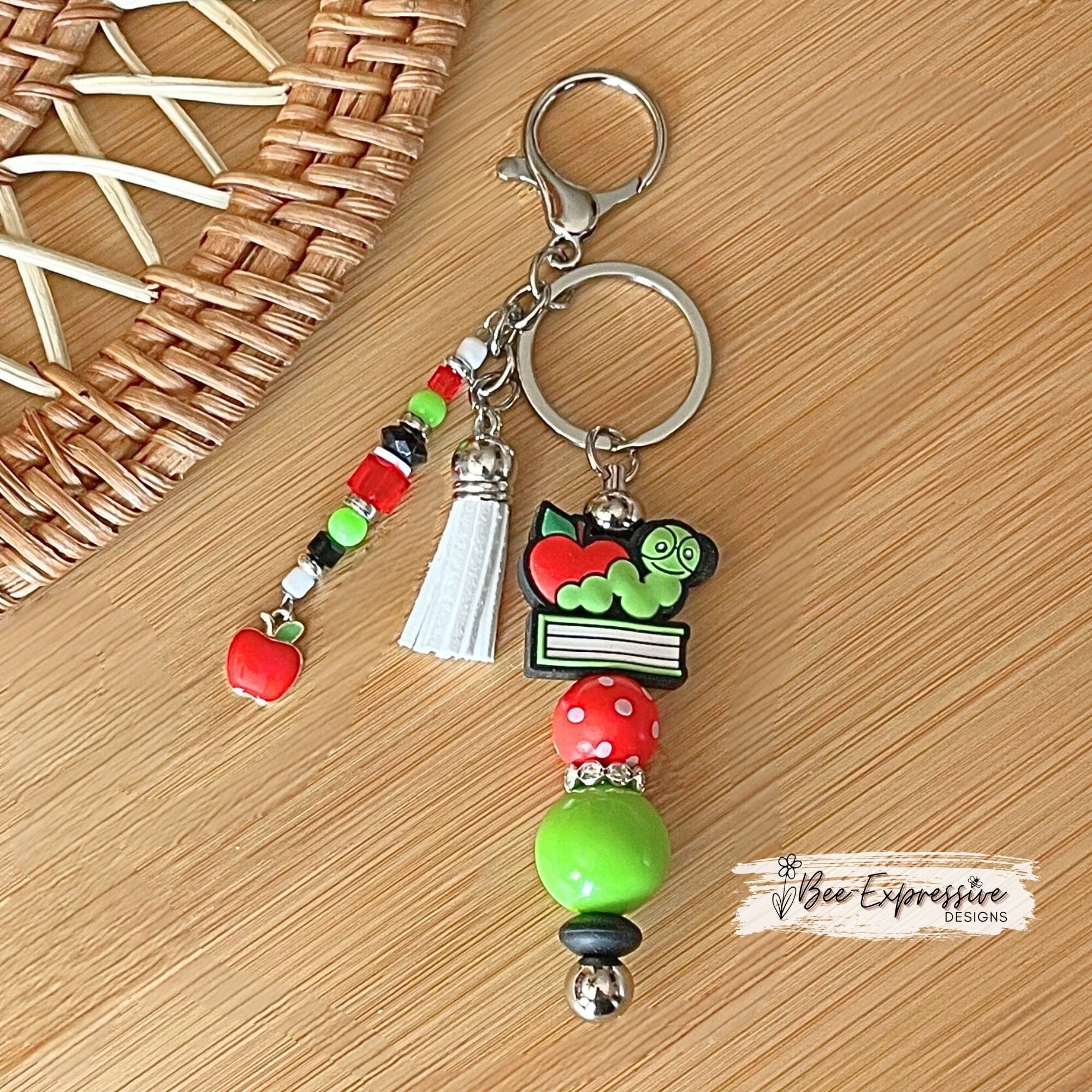 Handmade, unique, book worm teacher keychain! Lobster clasp, metal bar, 20” acrylic bead, beaded tassel with apple charm pendant!