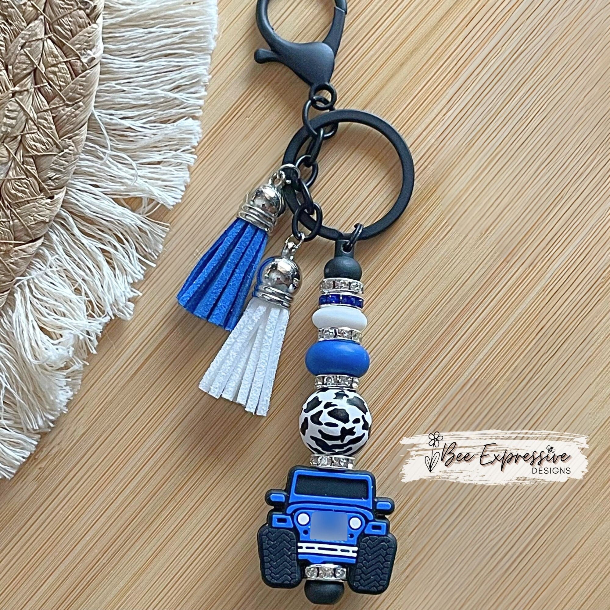 Unique and handmade, blue silicone 4x4 vehicle, metal keychain with a black animal print bead, silicone lentil beads and rhinestone spacers!