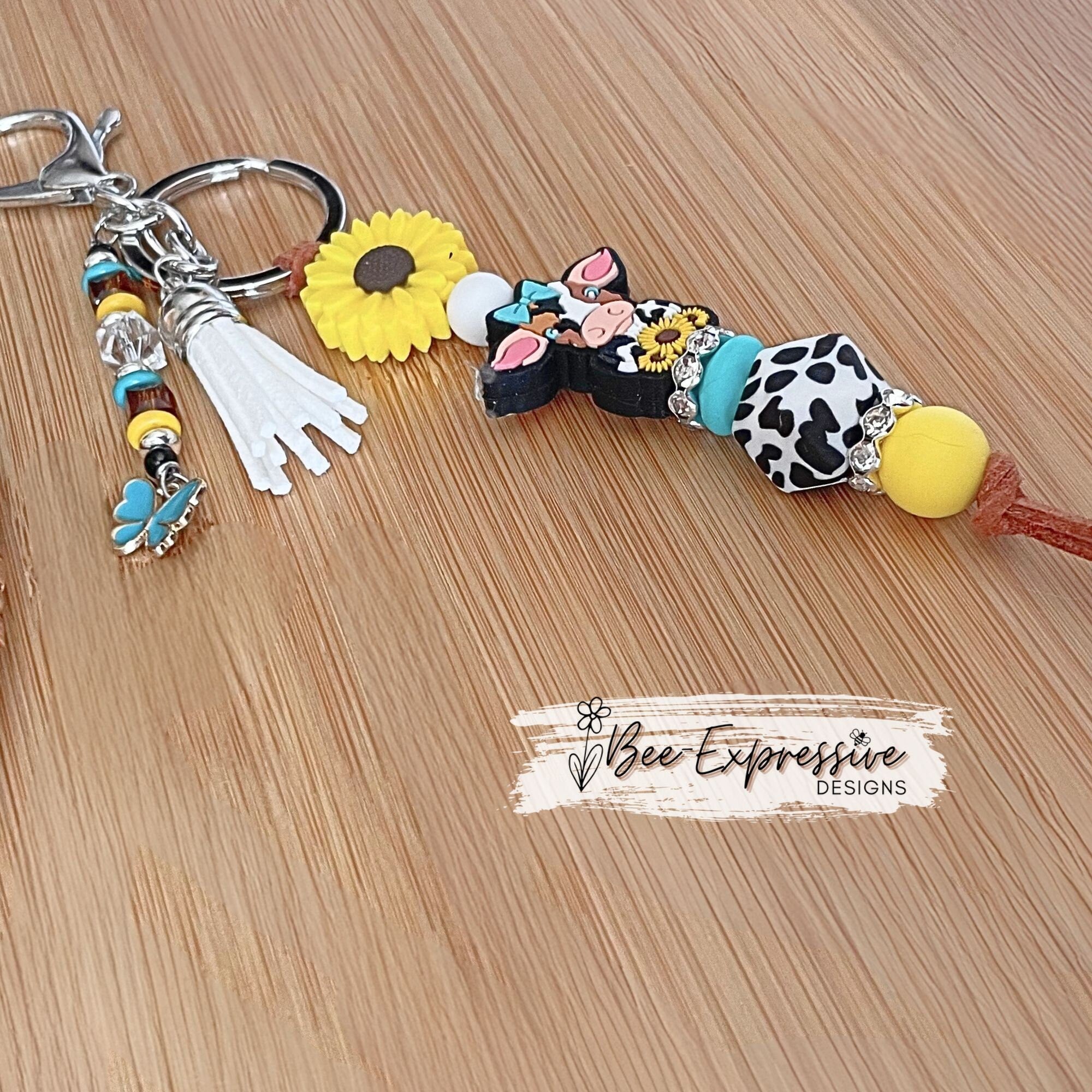 Silicone, DAIRY cow and SUNFLOWER keychain! Lobster or swivel clasp, suede cord, cow print octagon, beaded tassel with butterfly charm!